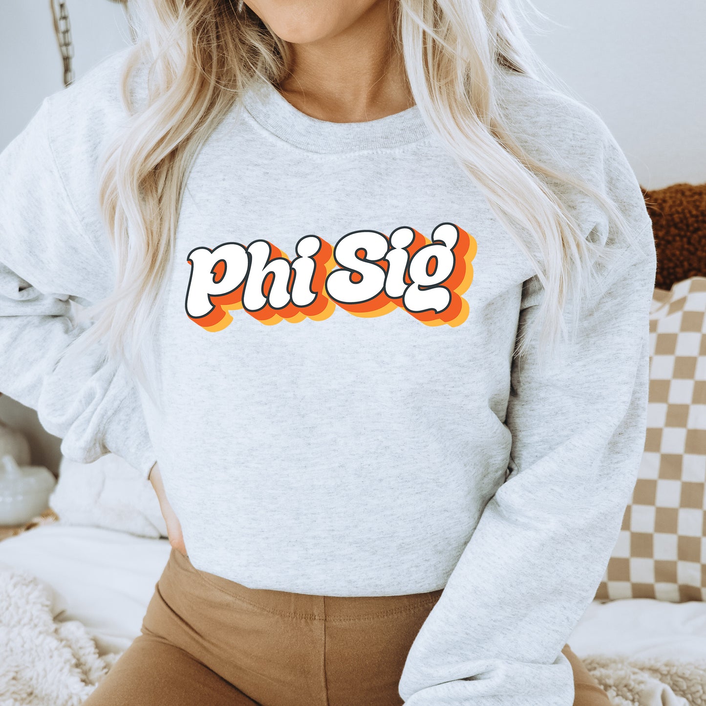 a woman wearing a sweatshirt with the word phi si on it