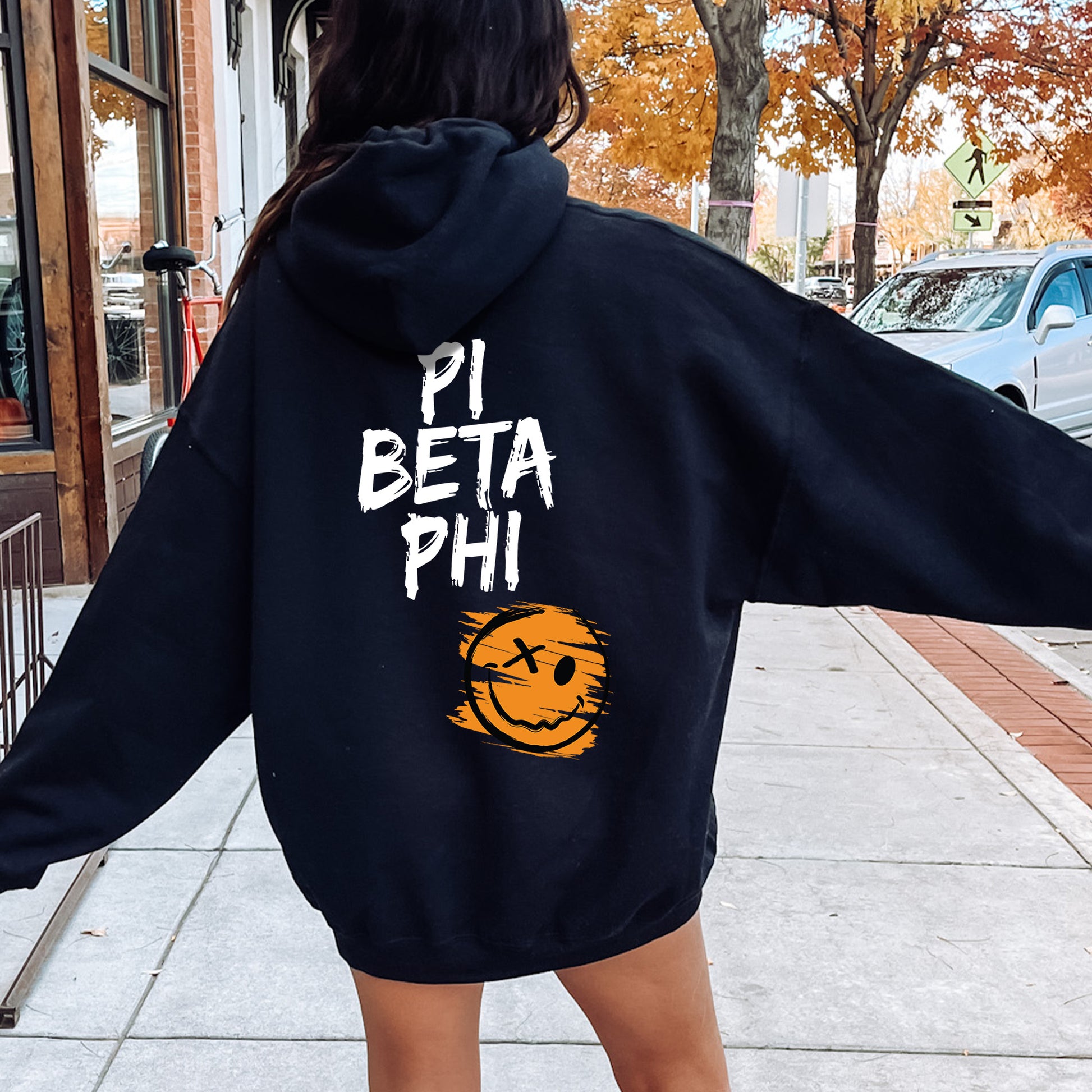 a woman in a black hoodie that says pi beta phi