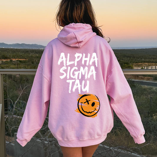 a girl wearing a pink sweatshirt with a smiley face on it