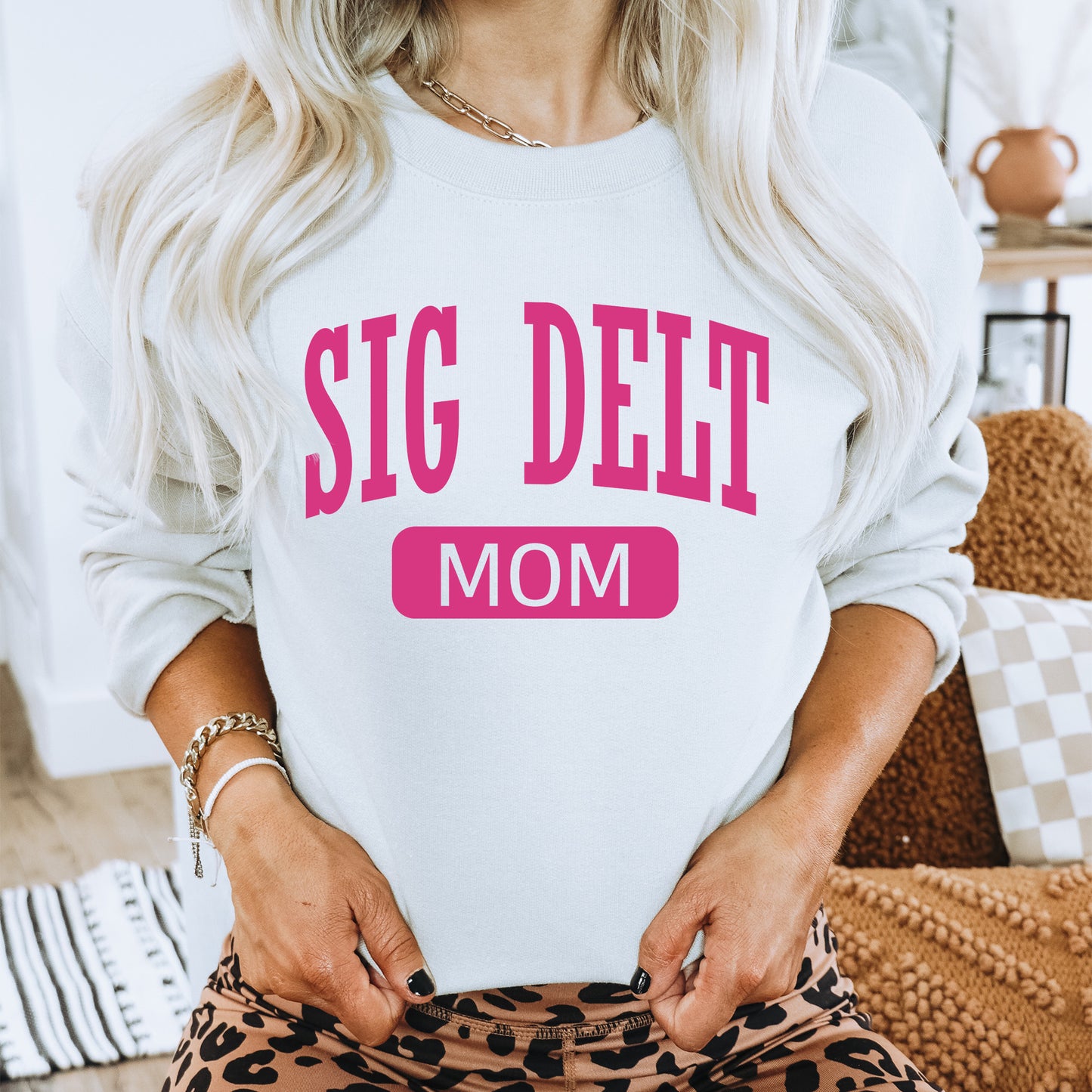 a woman in a white sweatshirt that says, sig deet mom