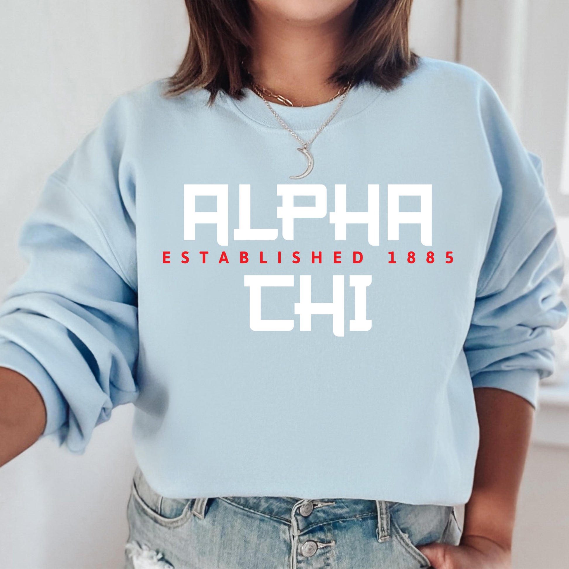 a woman wearing a blue sweatshirt with the words alphabet chii printed on it