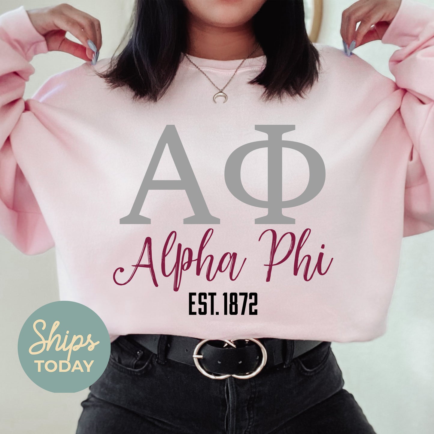 a woman wearing a pink shirt with a phi phi on it