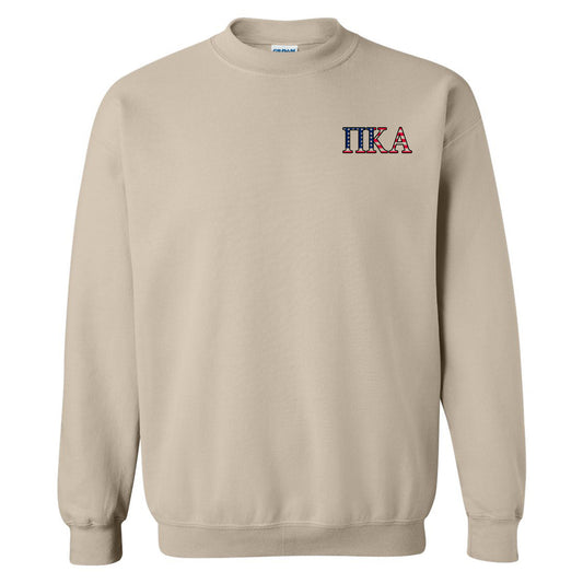 a beige sweatshirt with the letters itka on it