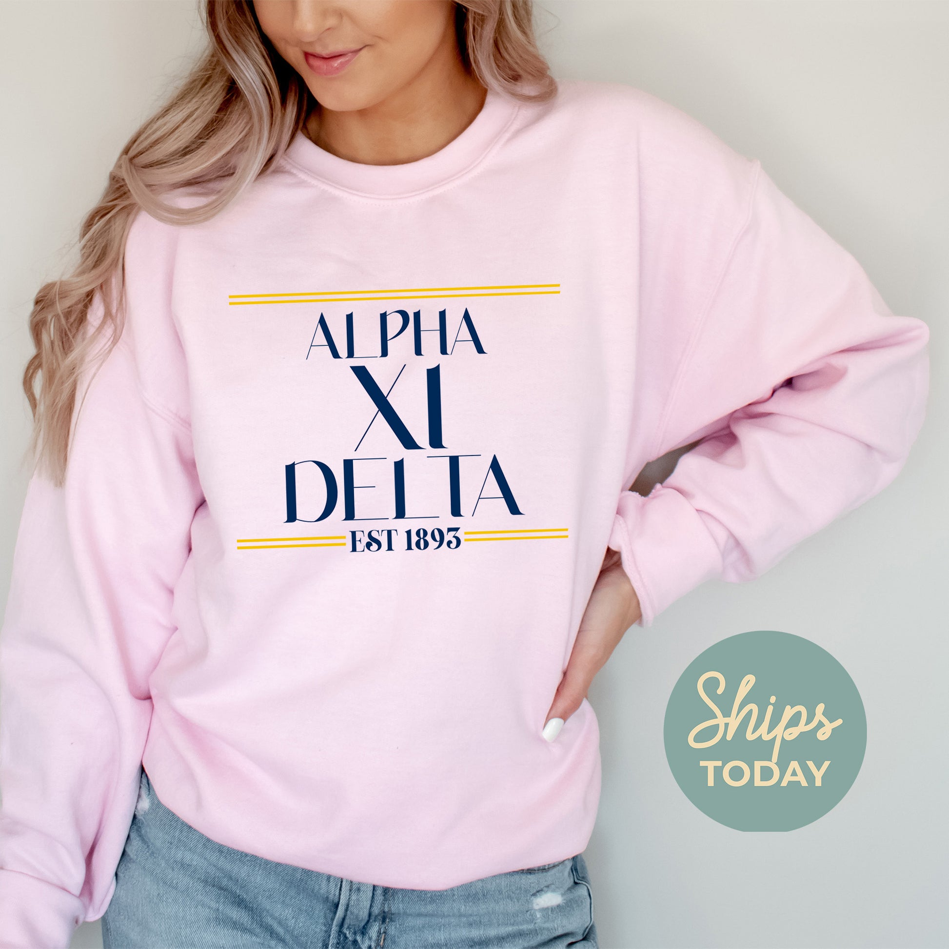 a woman wearing a pink sweatshirt and jeans