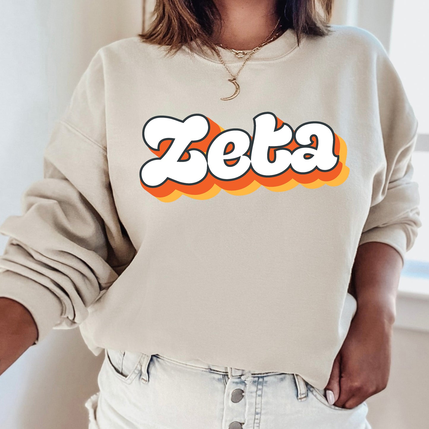 a woman wearing a sweatshirt with the word zeba on it