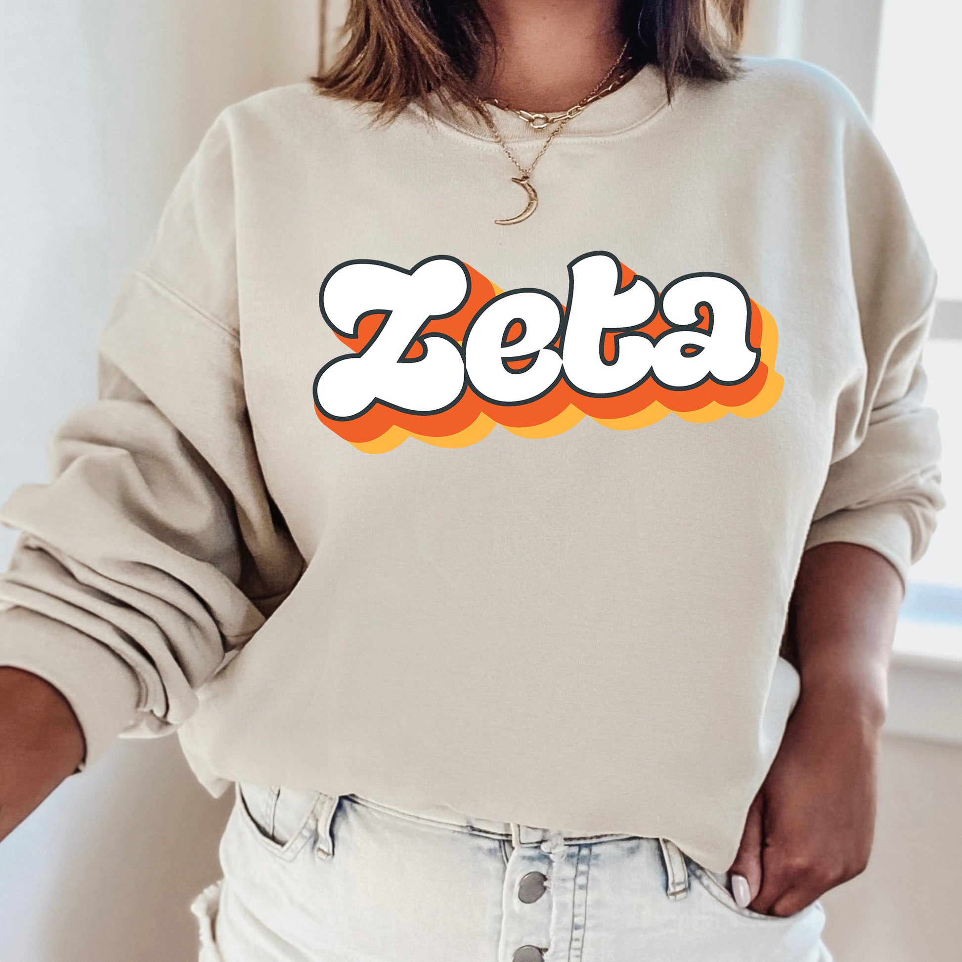a woman wearing a sweatshirt with the word zeba on it