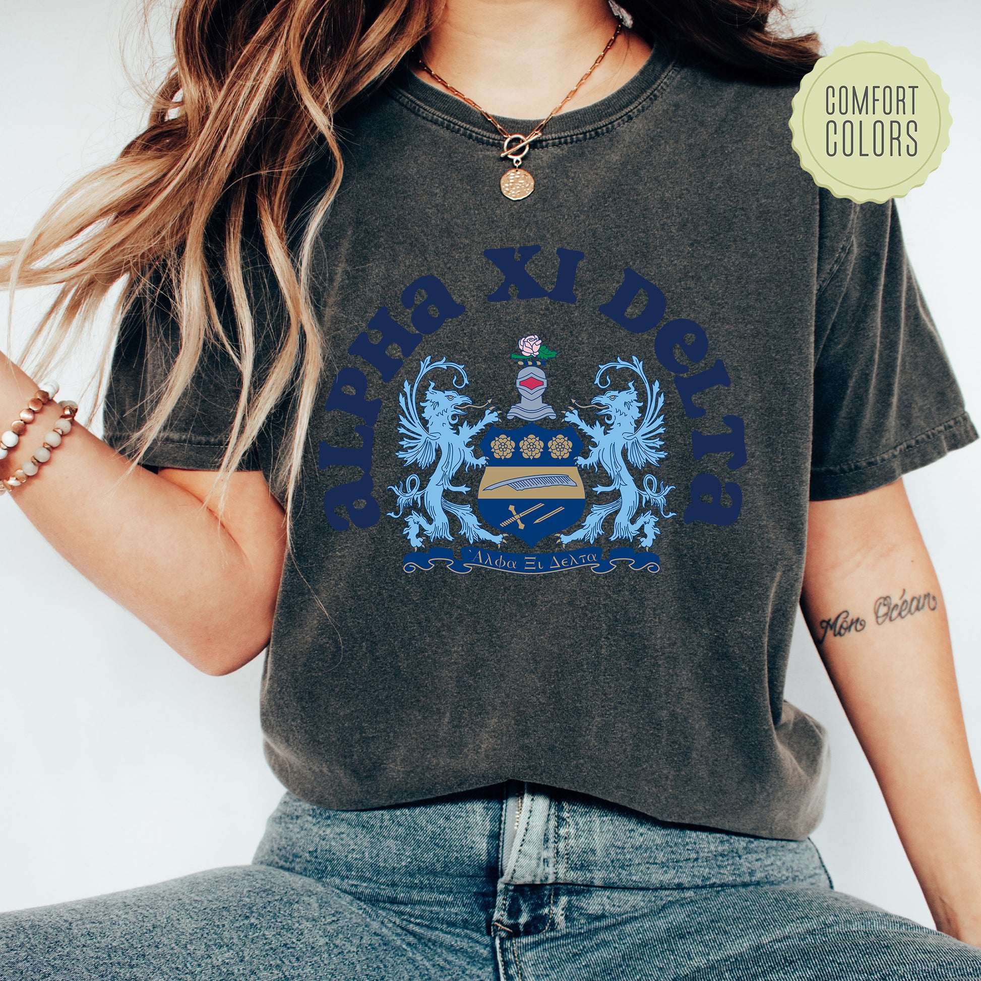 a woman wearing a black shirt with a blue crown on it