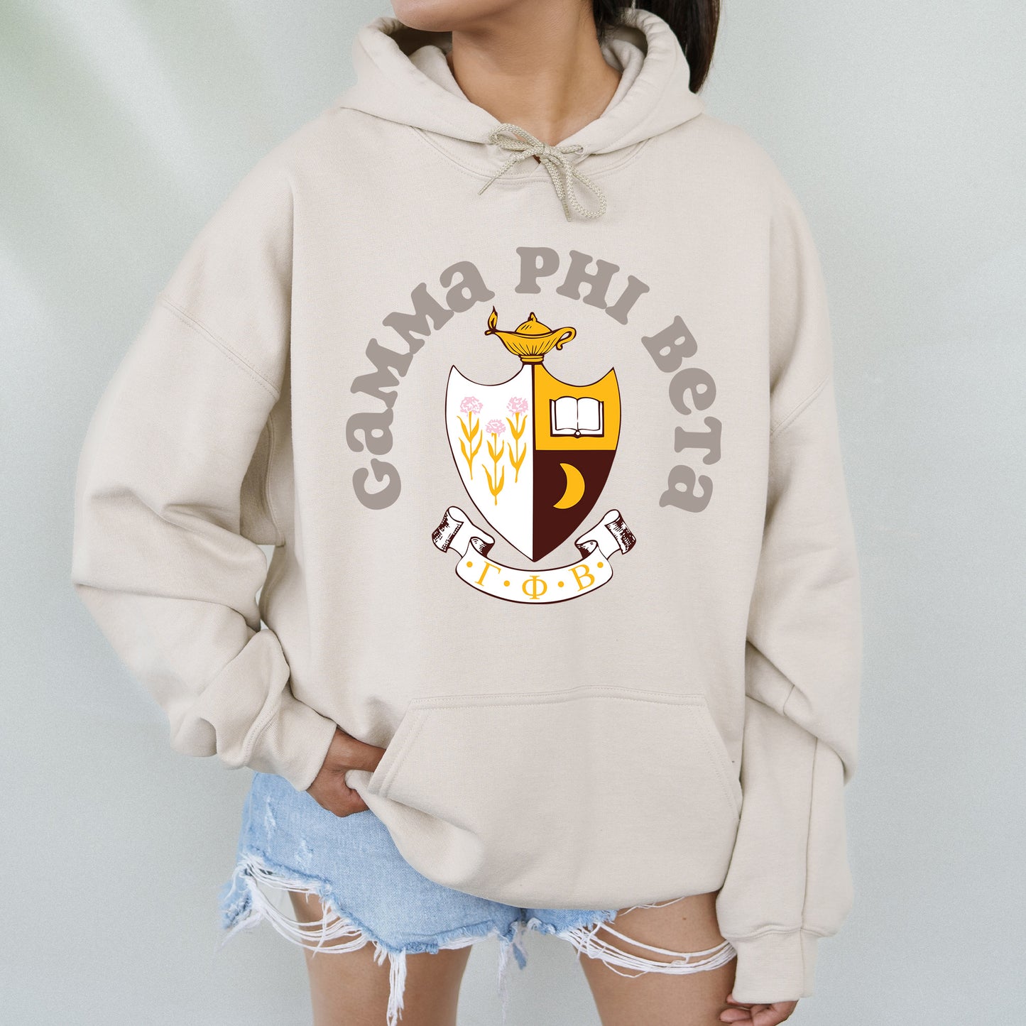 a woman wearing a white hoodie with a crest on it