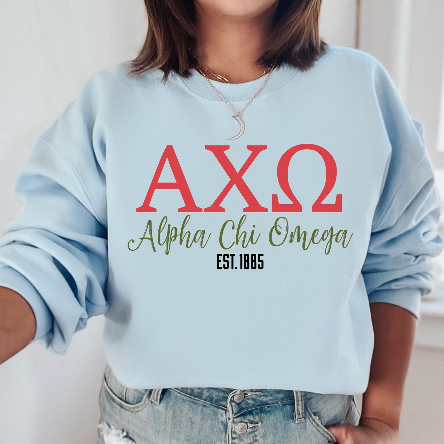 a woman wearing a blue sweatshirt with the letters axq on it