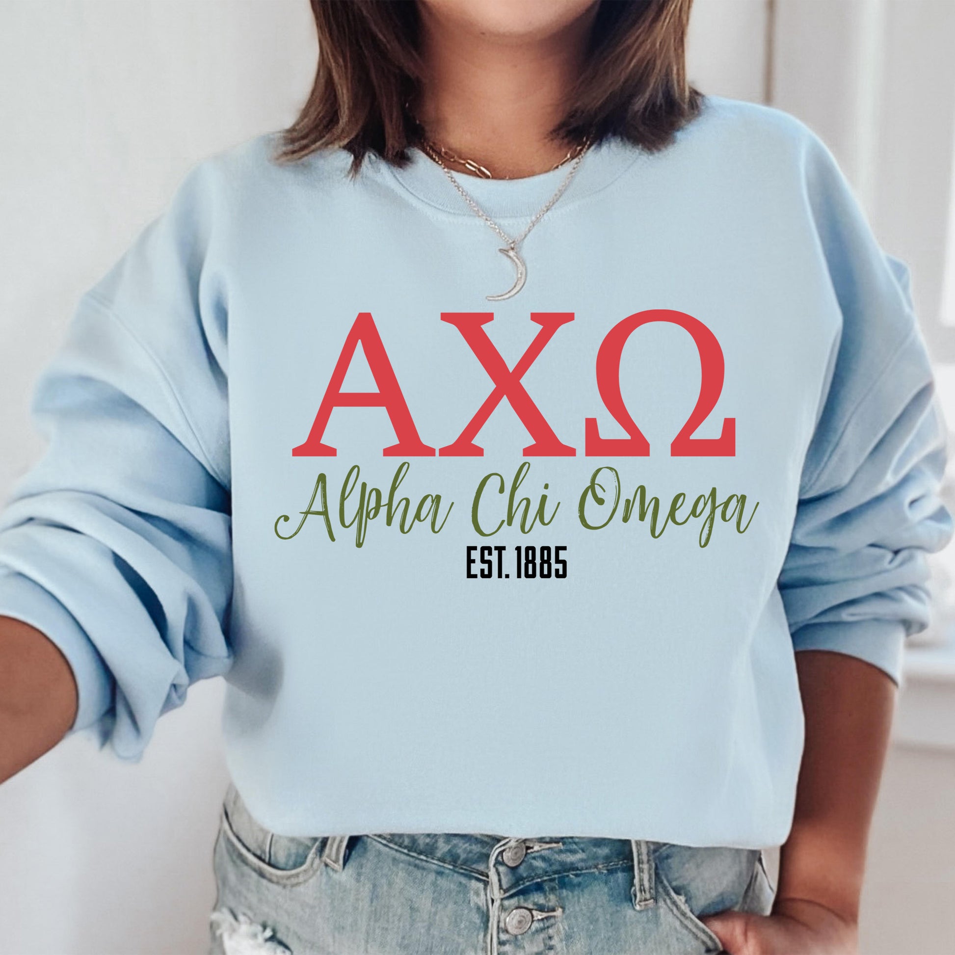 a woman wearing a blue sweatshirt with the letters axq on it