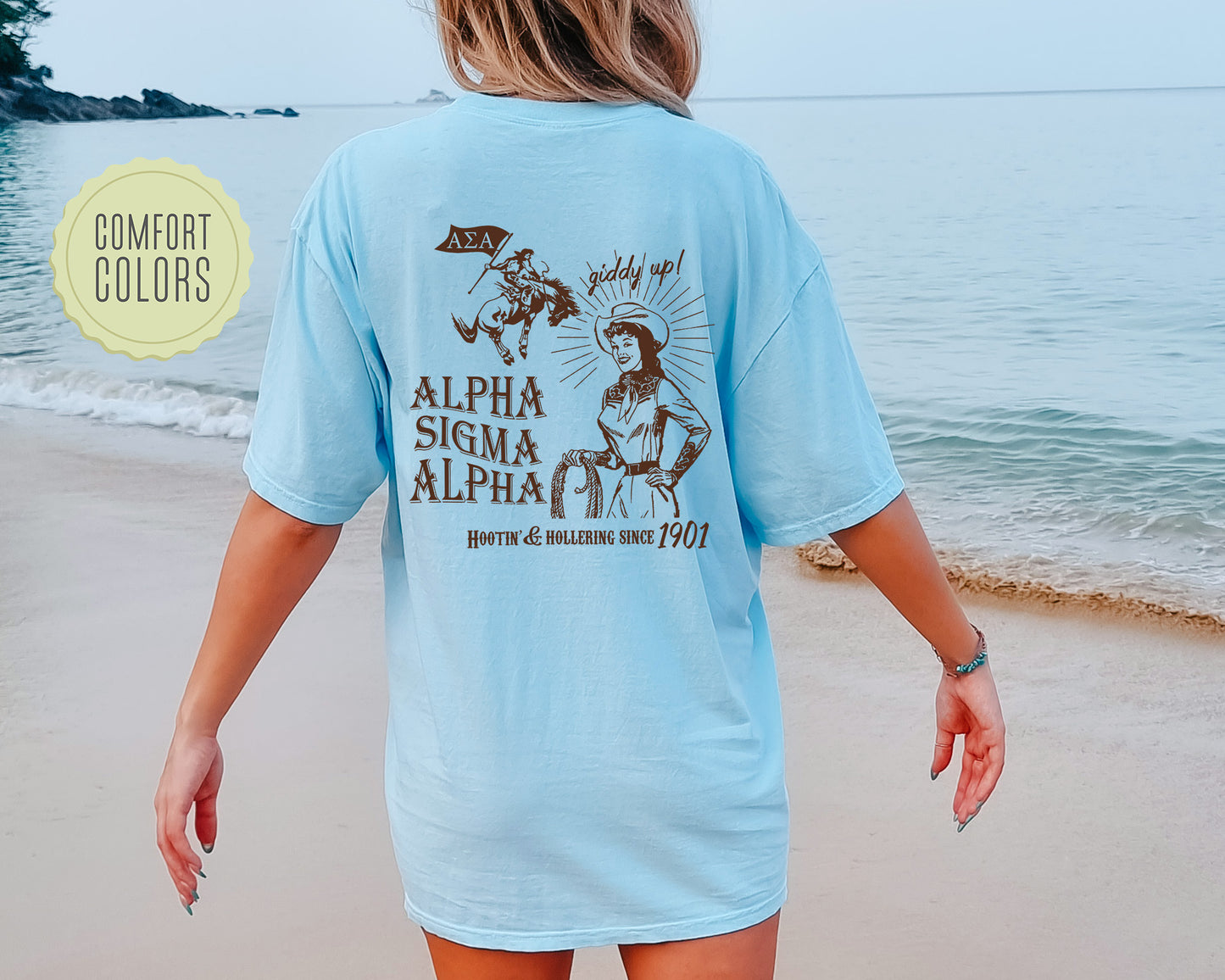 a woman walking on the beach wearing a blue shirt