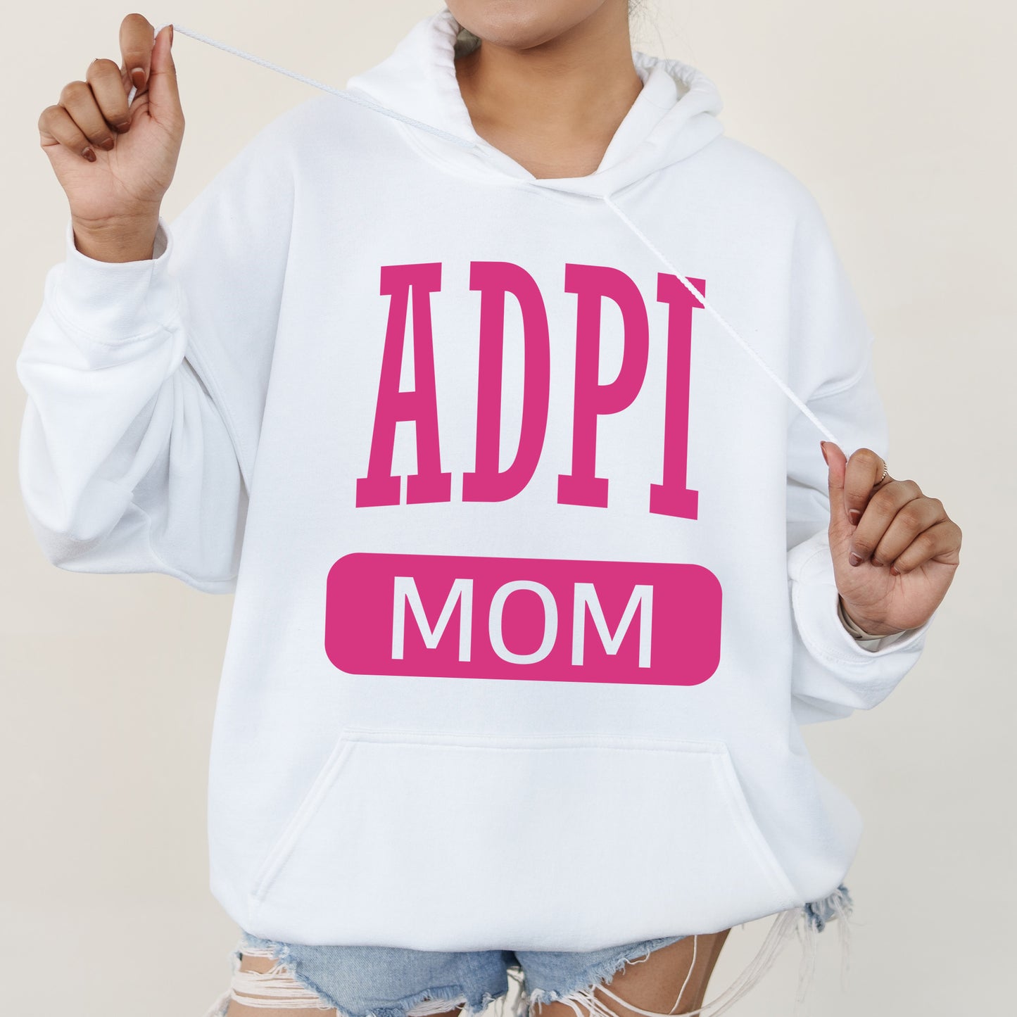 a woman wearing a white hoodie with the word appi mom printed on it