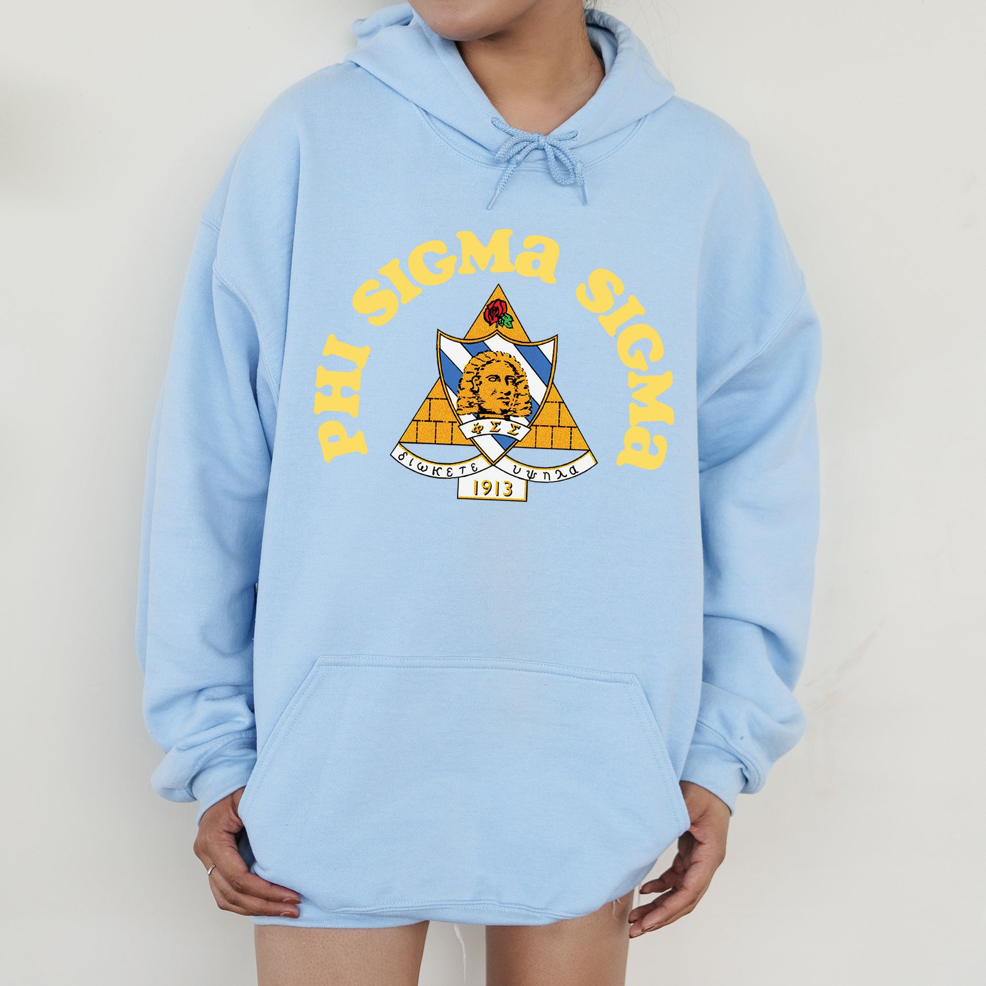 a person wearing a blue hoodie with a pyramid on it