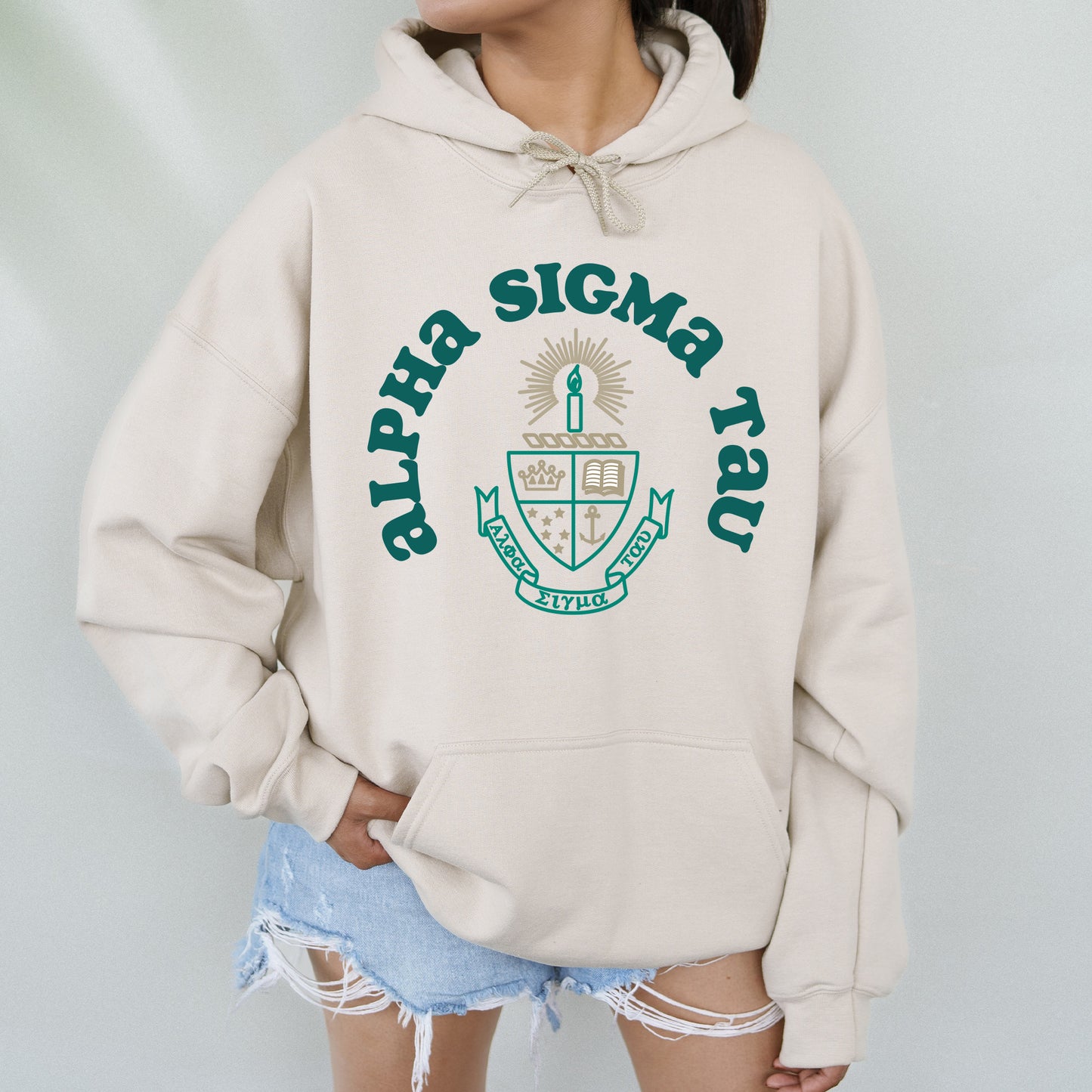 a woman wearing a white sweatshirt with a green logo on it