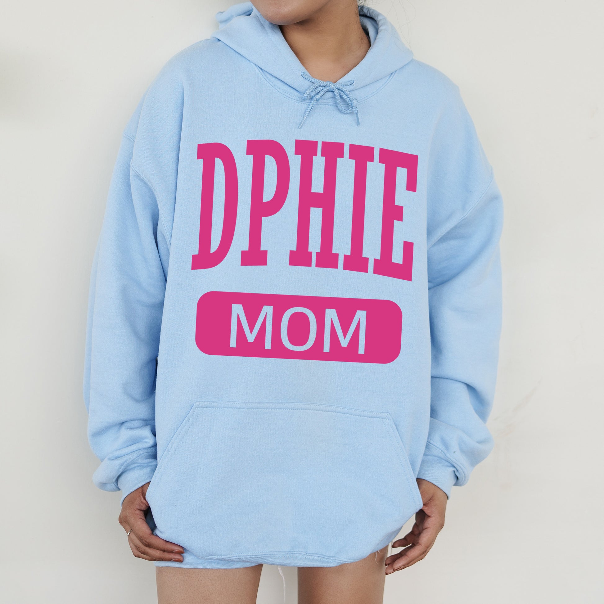 a woman wearing a blue hoodie that says dppie mom