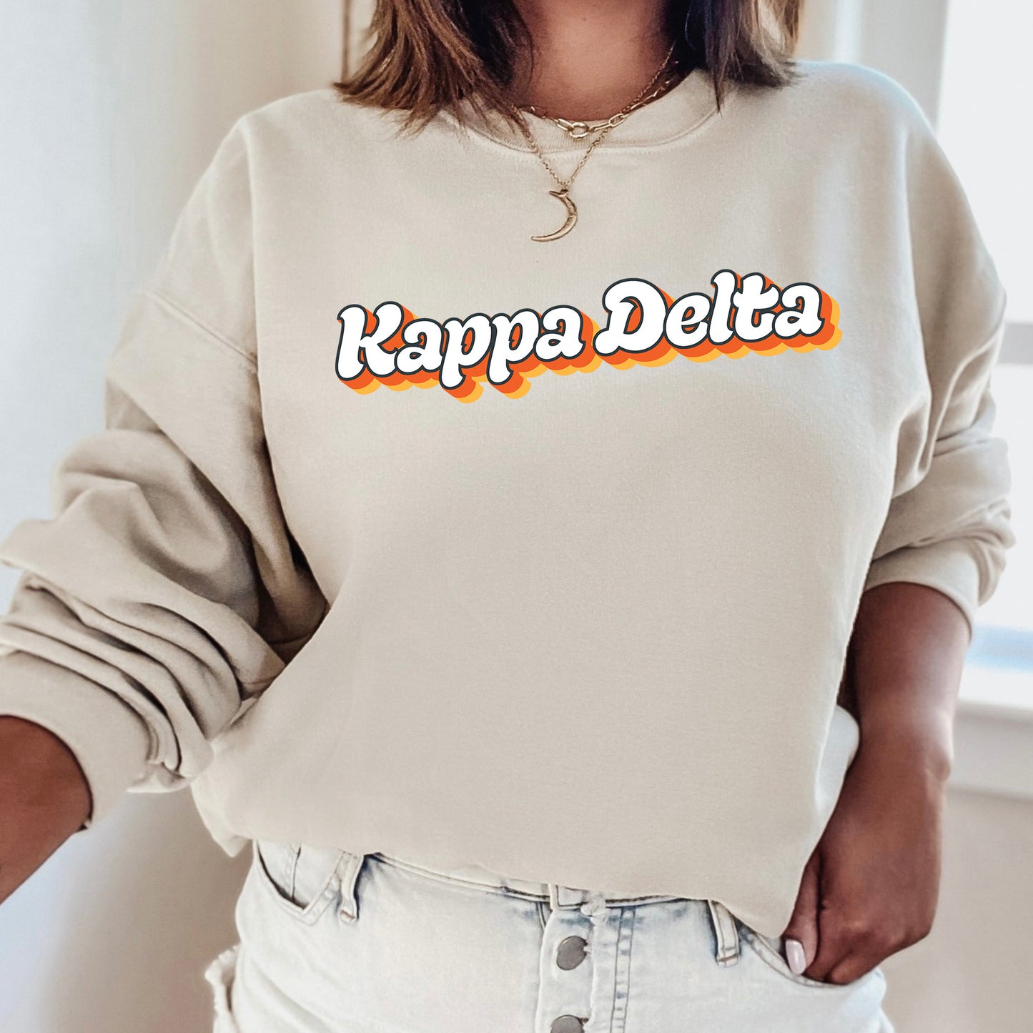 a woman wearing a sweatshirt that says kappa delta