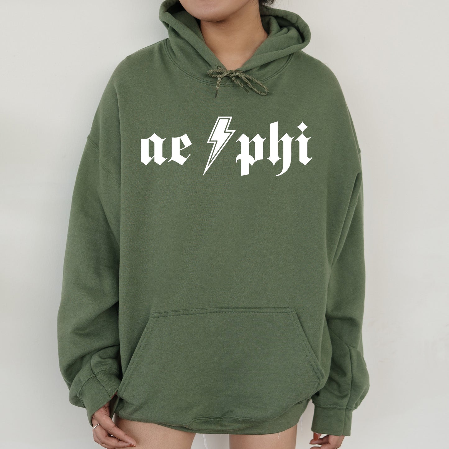 a person wearing a green hoodie with a lightning bolt on it