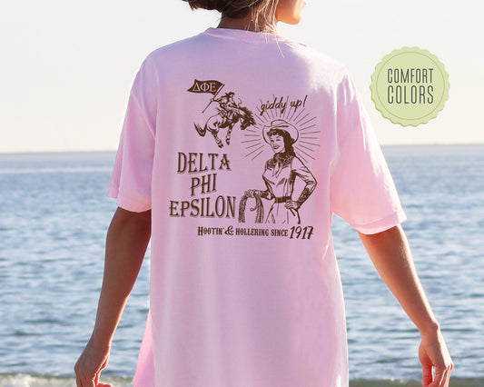 a woman in a pink shirt standing on a beach