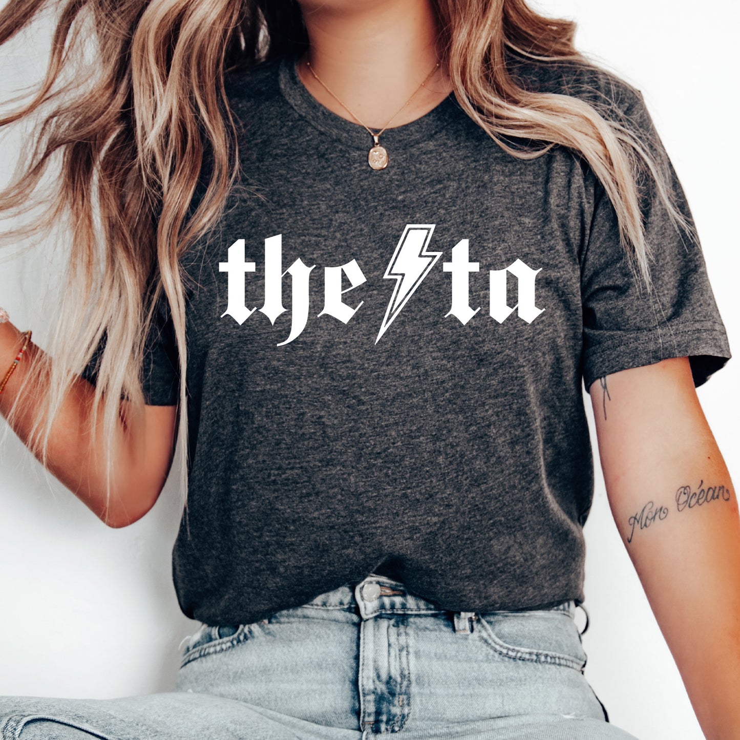 a woman wearing a t - shirt with the word the stoo on it