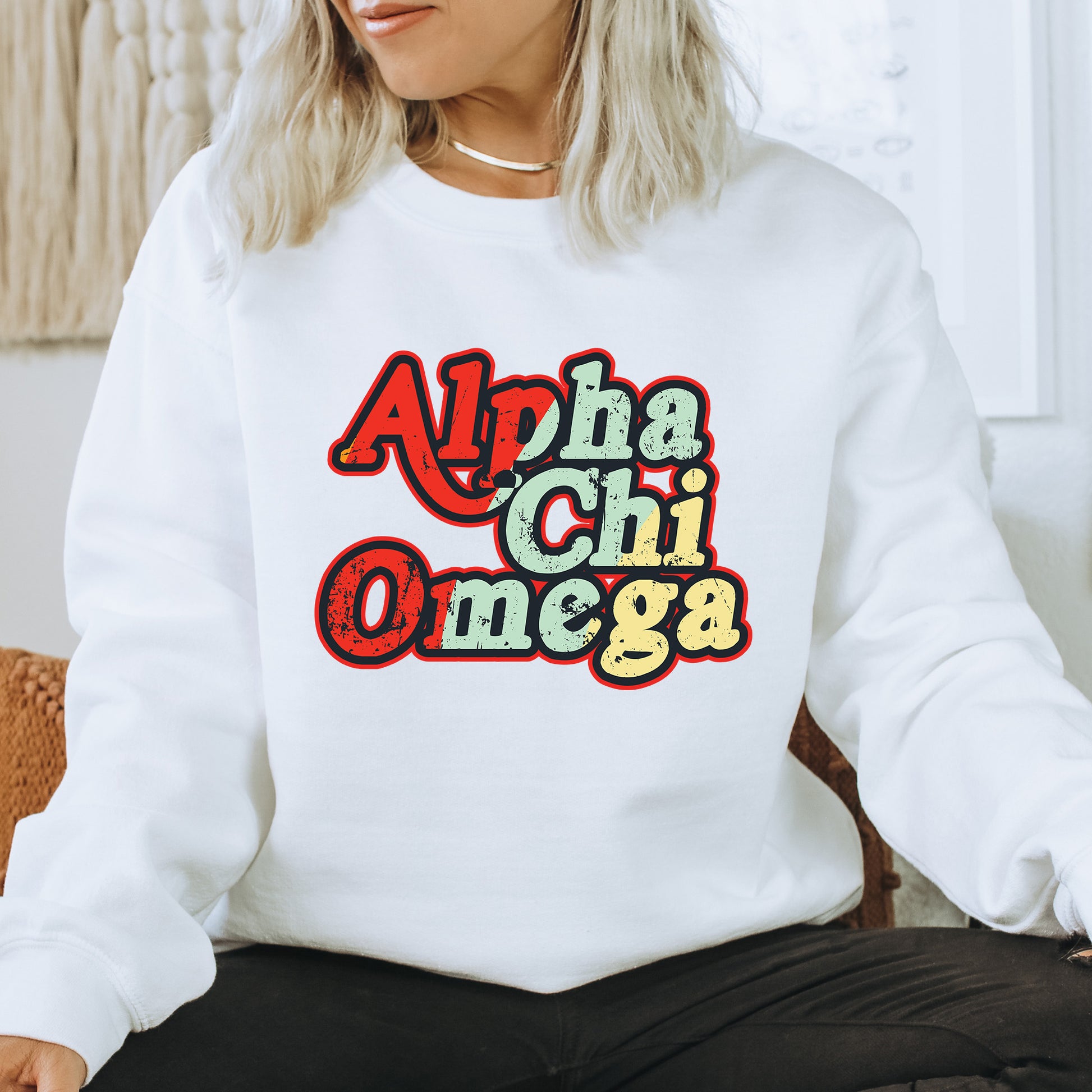 a woman sitting on a chair wearing a white sweatshirt