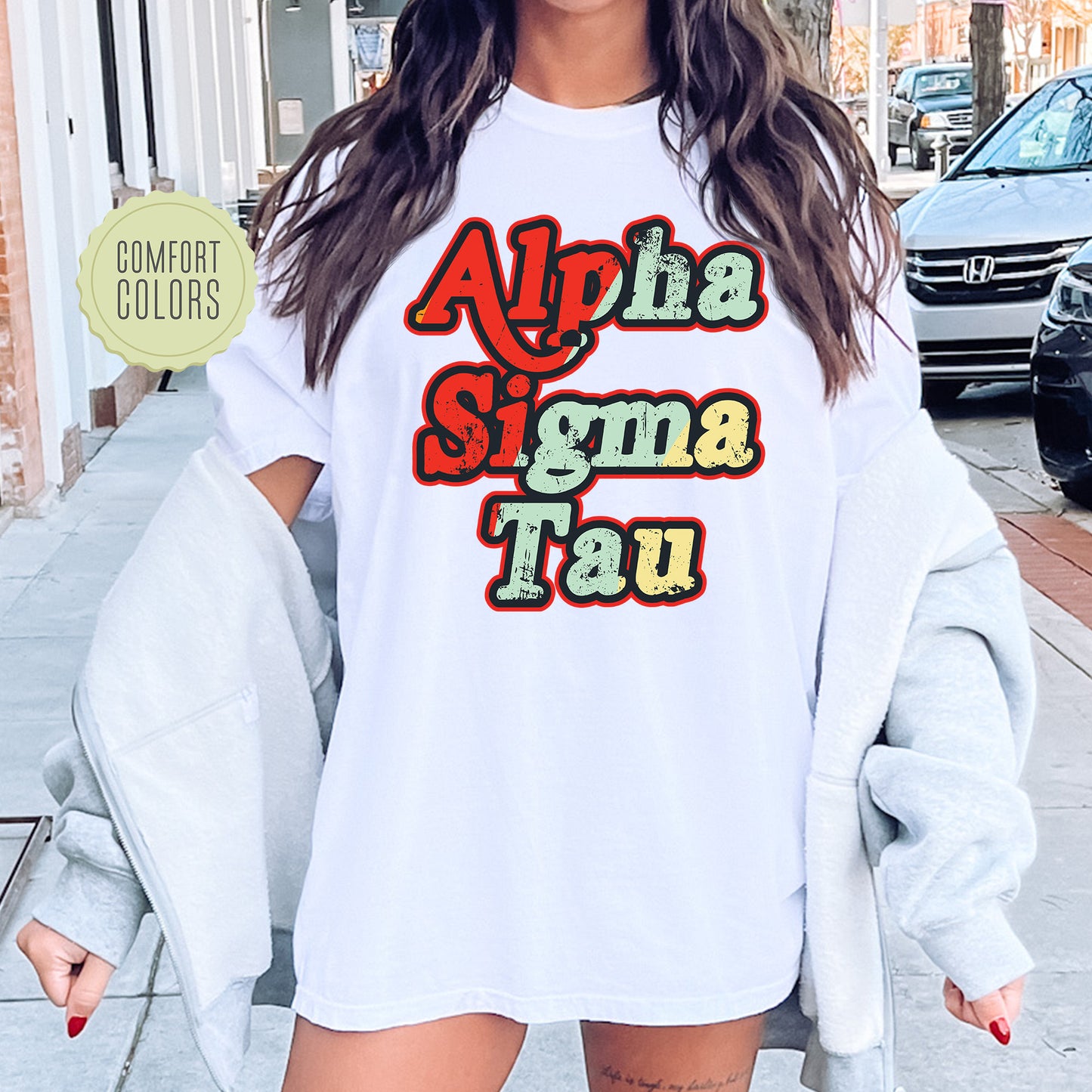 a woman wearing a white shirt that says, ahha sigma tau