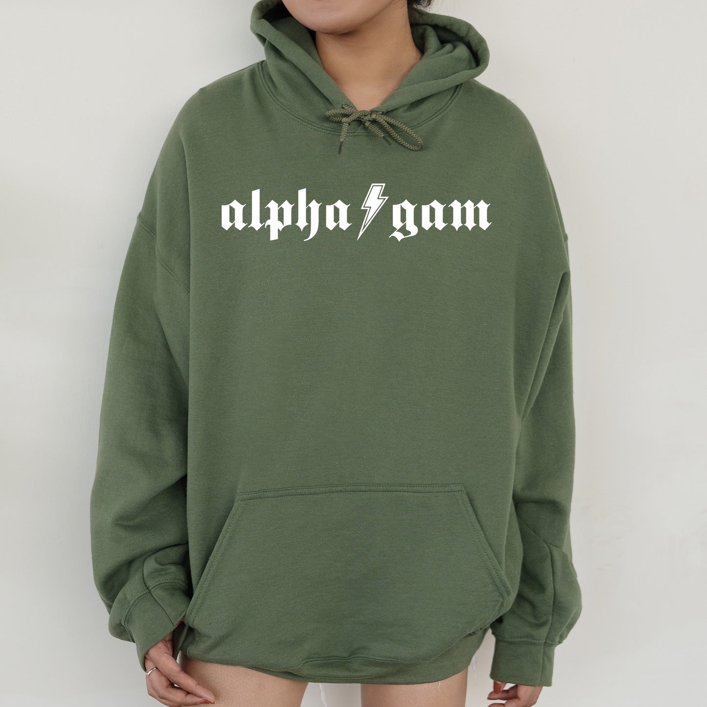 a person wearing a green sweatshirt with the word alphonagm printed on it