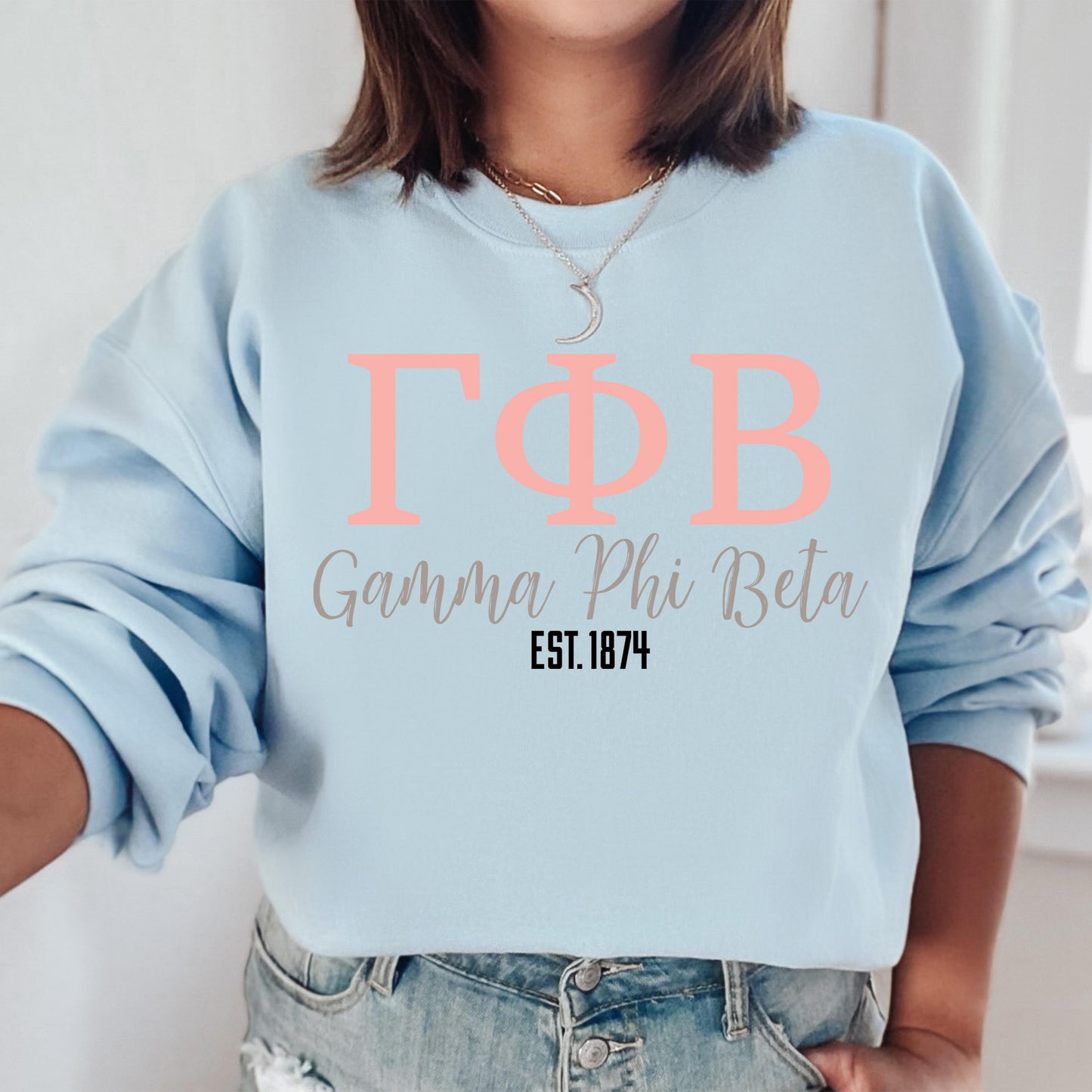 a woman wearing a light blue sweatshirt with the words tob on it
