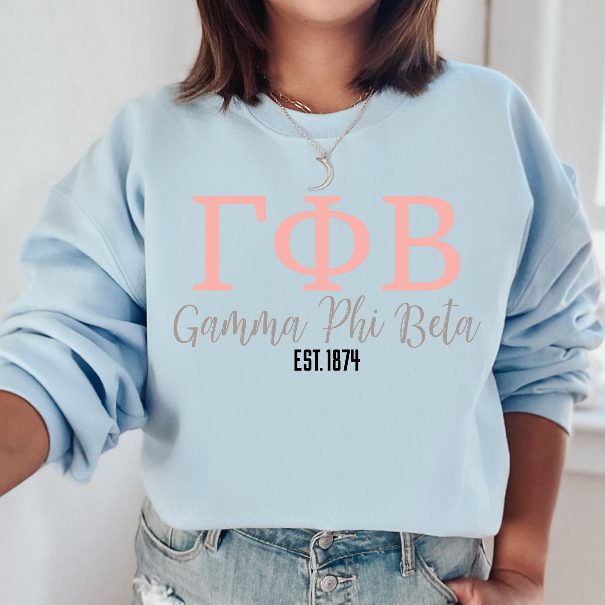 a woman wearing a light blue sweatshirt with the words tob on it