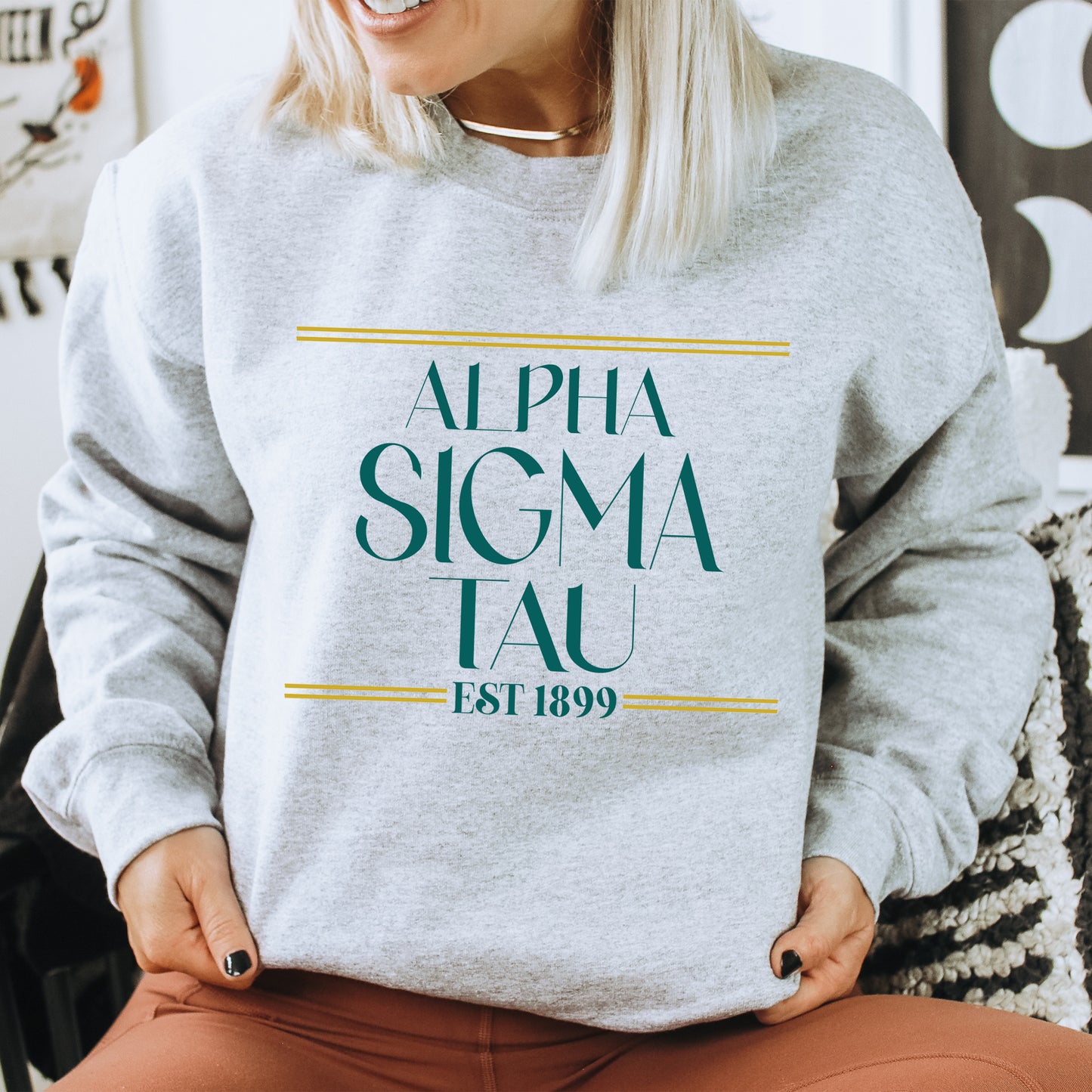 a woman sitting on a chair wearing a sweatshirt
