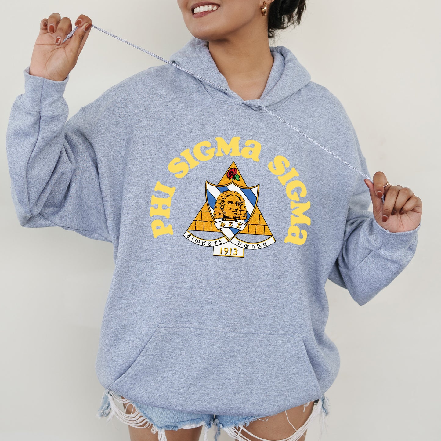 a woman wearing a blue hoodie with an emblem on it