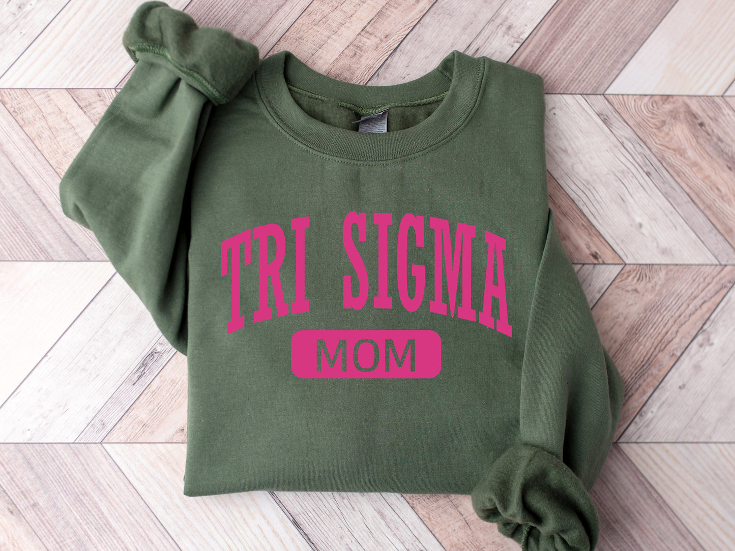 a green sweatshirt with the word tri stigma on it