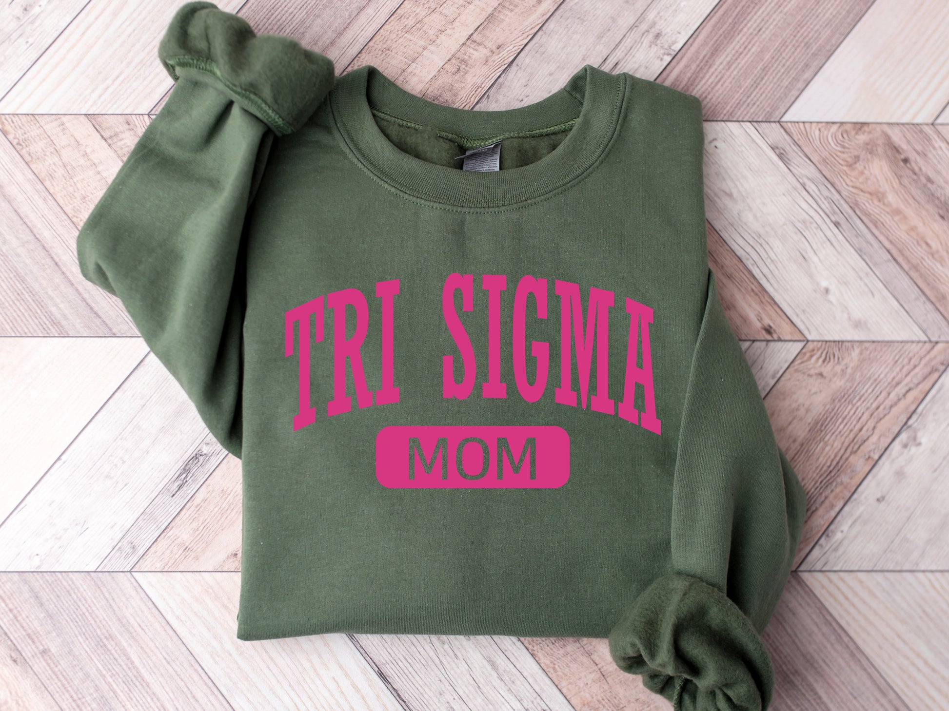 a green sweatshirt with the word tri stigma on it