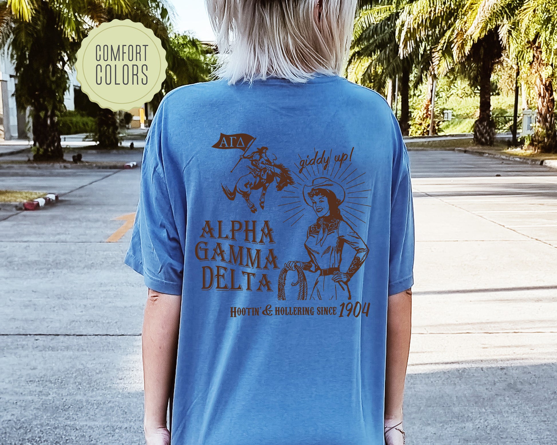 a woman wearing a blue shirt with a picture of a woman riding a horse