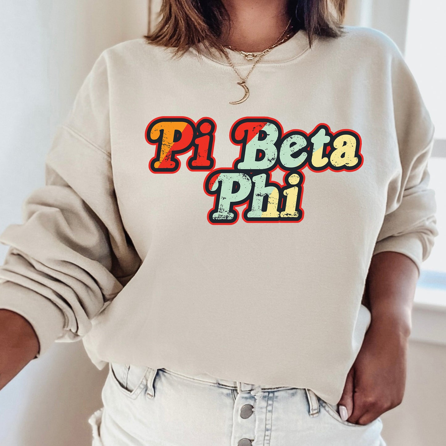 a woman wearing a sweatshirt that says pi beta phi
