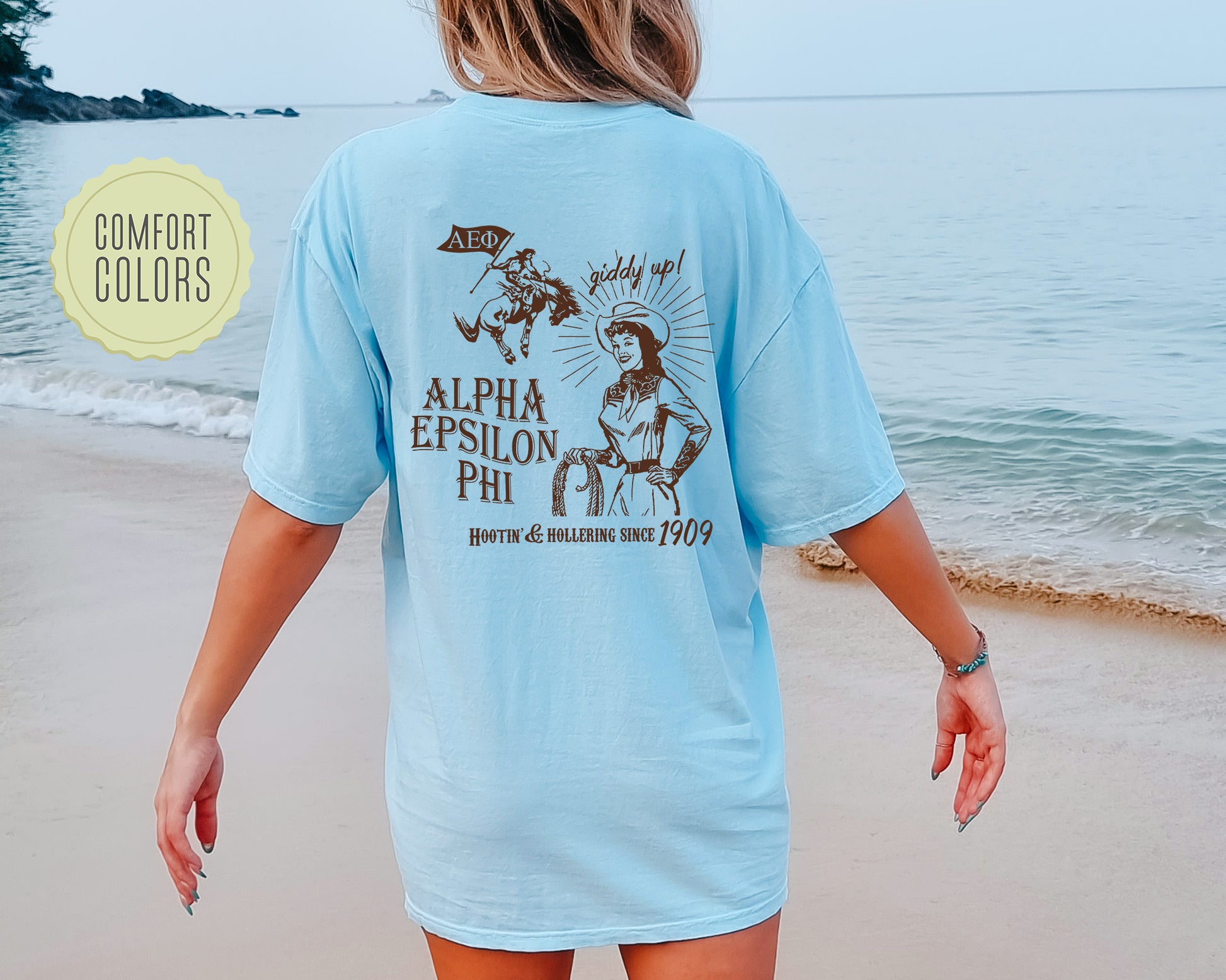 a woman walking on a beach next to the ocean