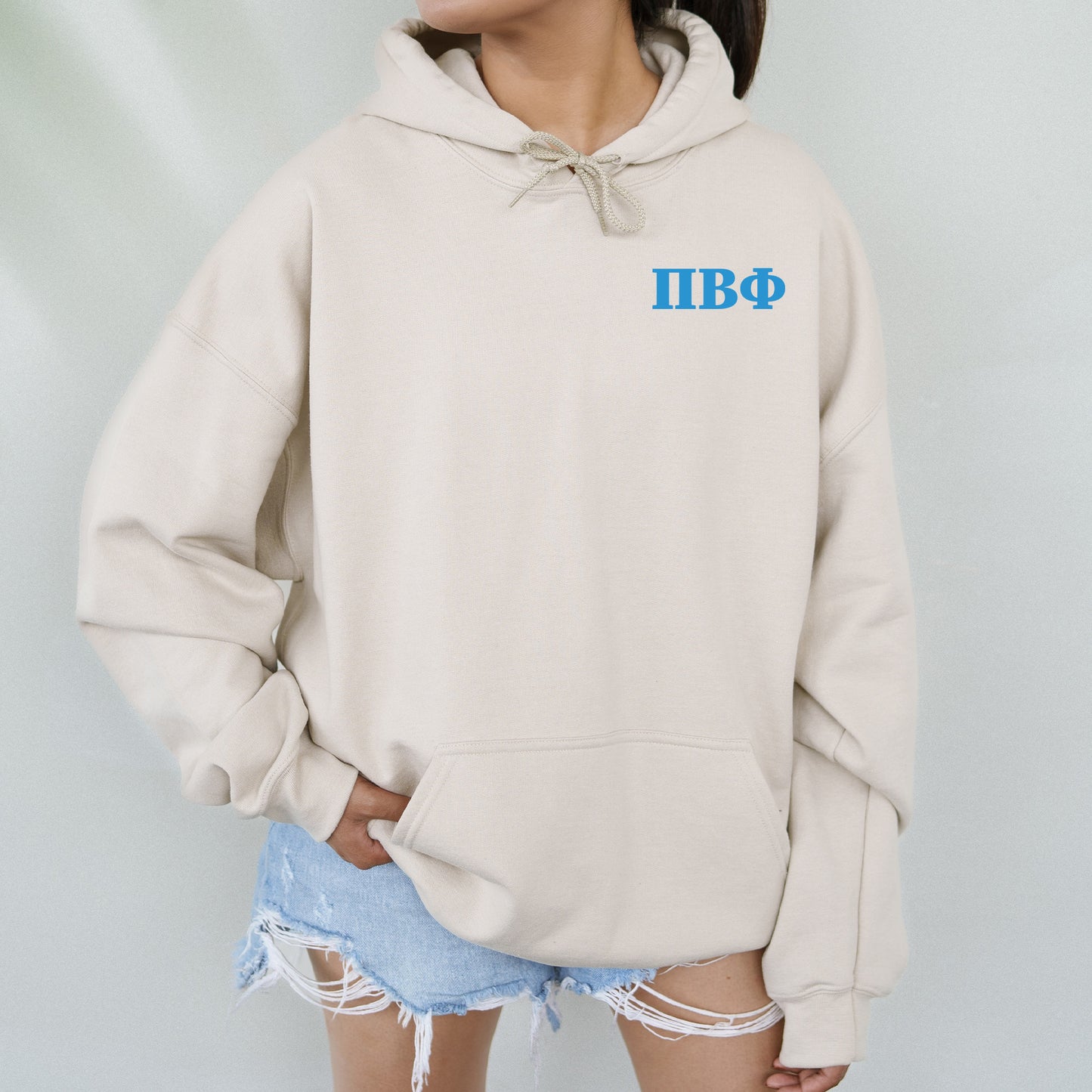 a woman wearing a white hoodie with blue letters on it