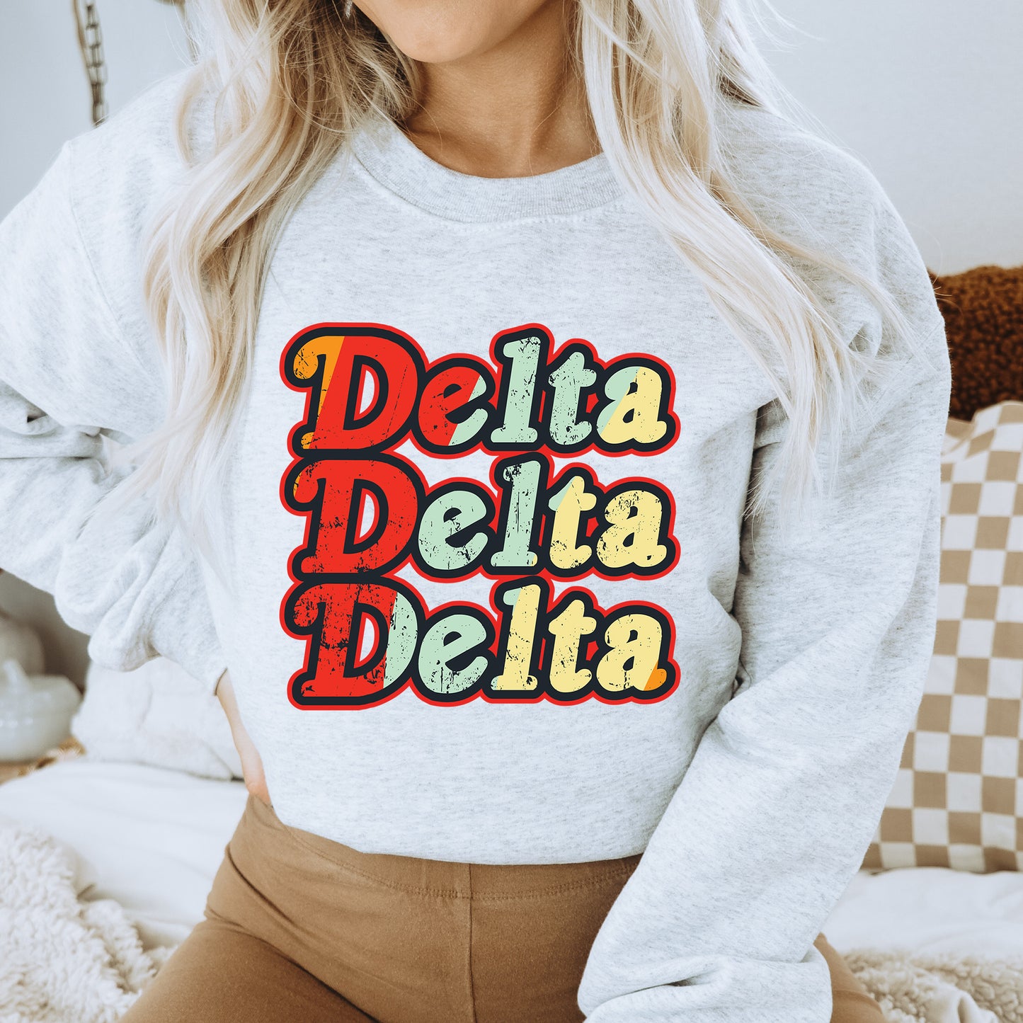 a woman wearing a sweatshirt that says delta delta