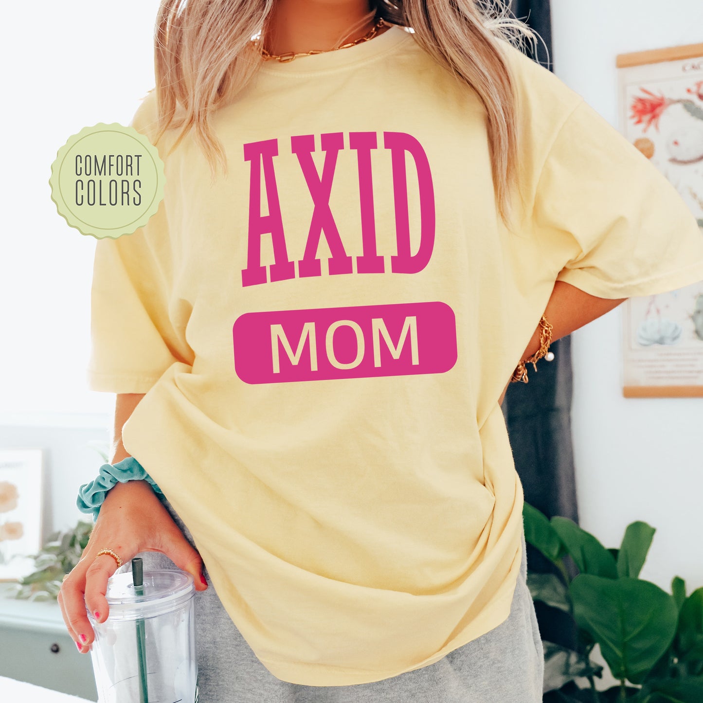 a woman in a yellow shirt holding a blender