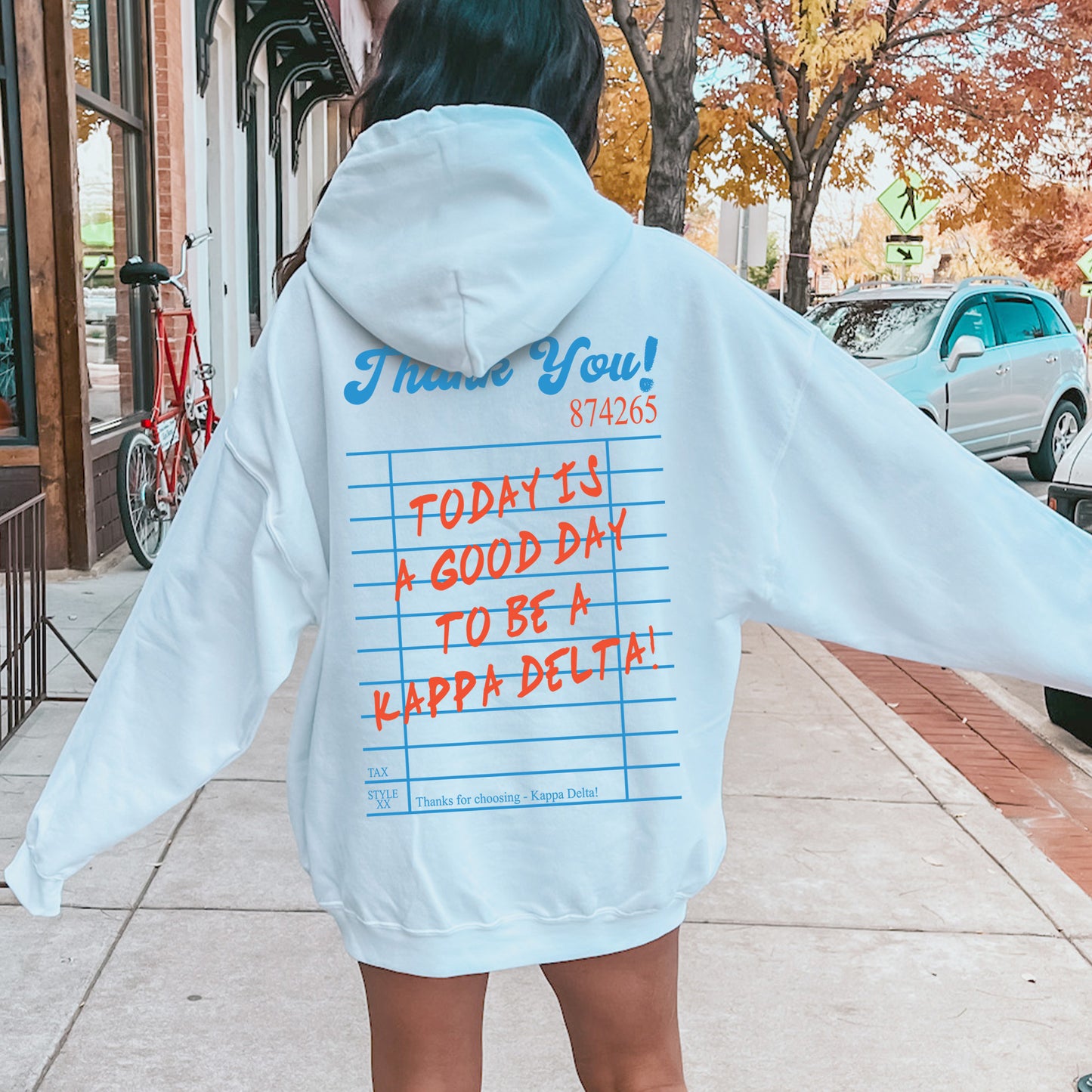 a woman in a white hoodie with writing on it