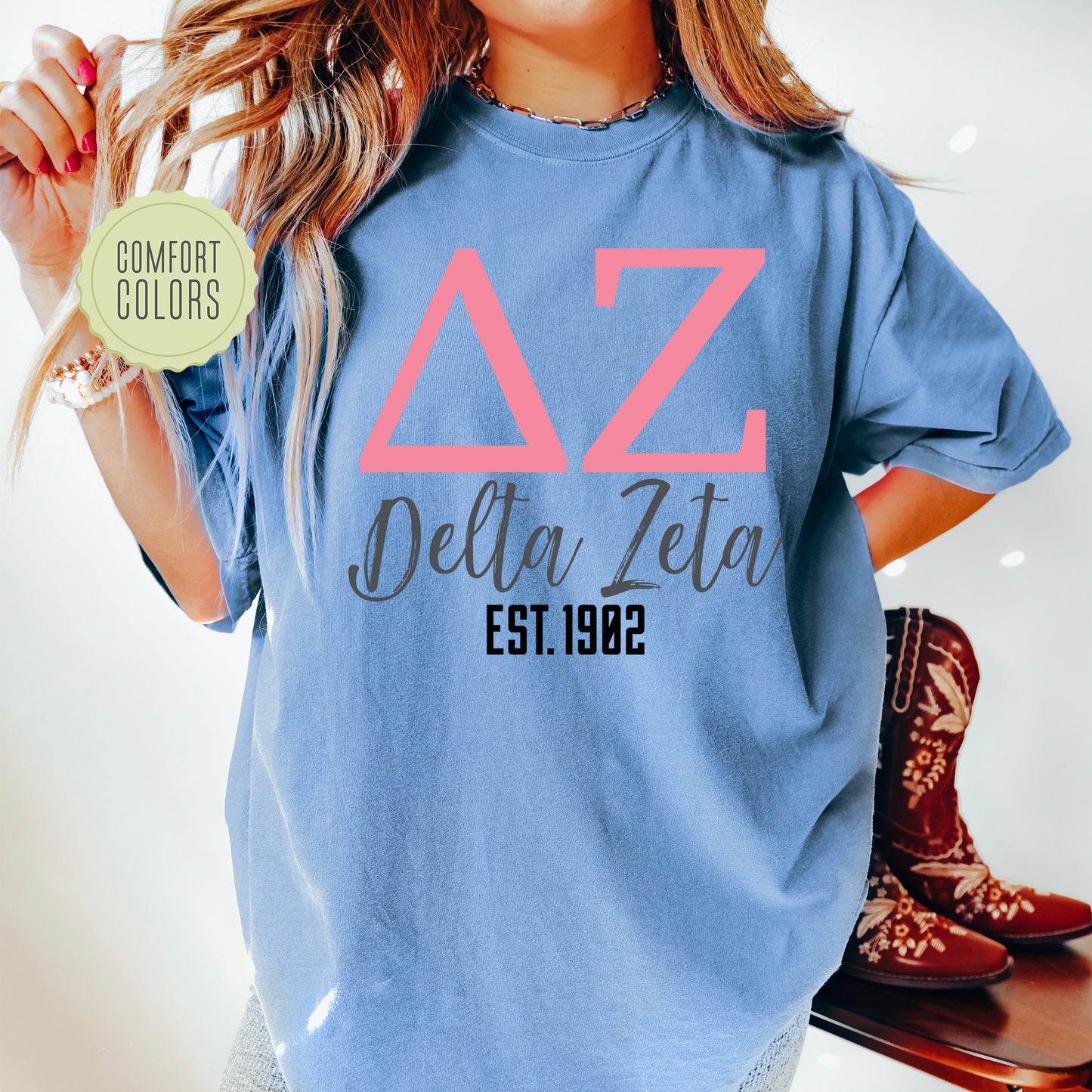 a woman wearing a blue delta delta shirt