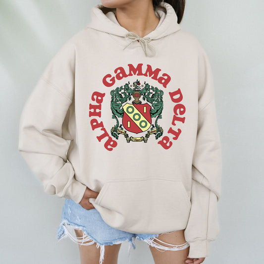 a woman wearing a white hoodie with a crest on it