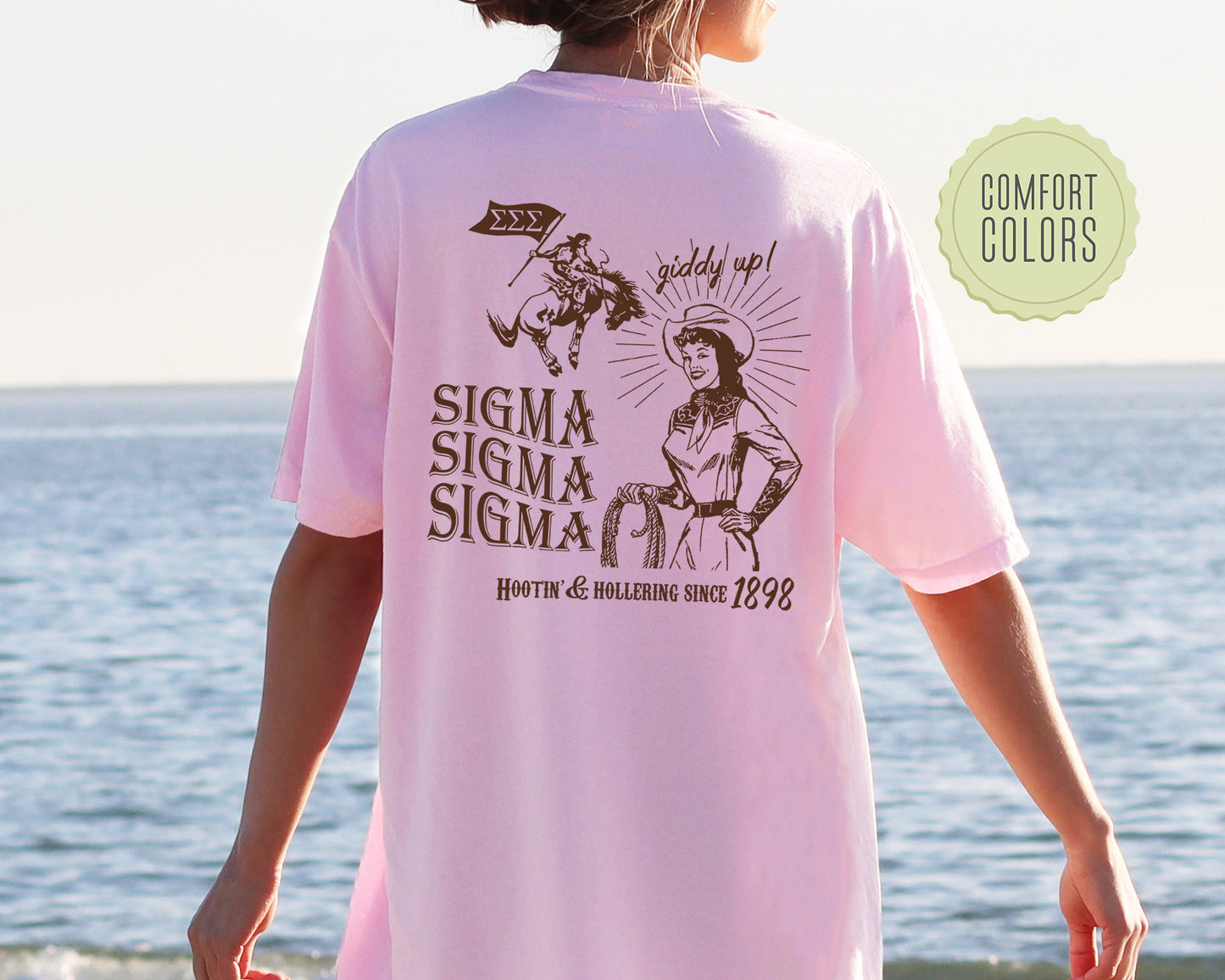 a woman wearing a pink shirt with a picture of a man riding a horse