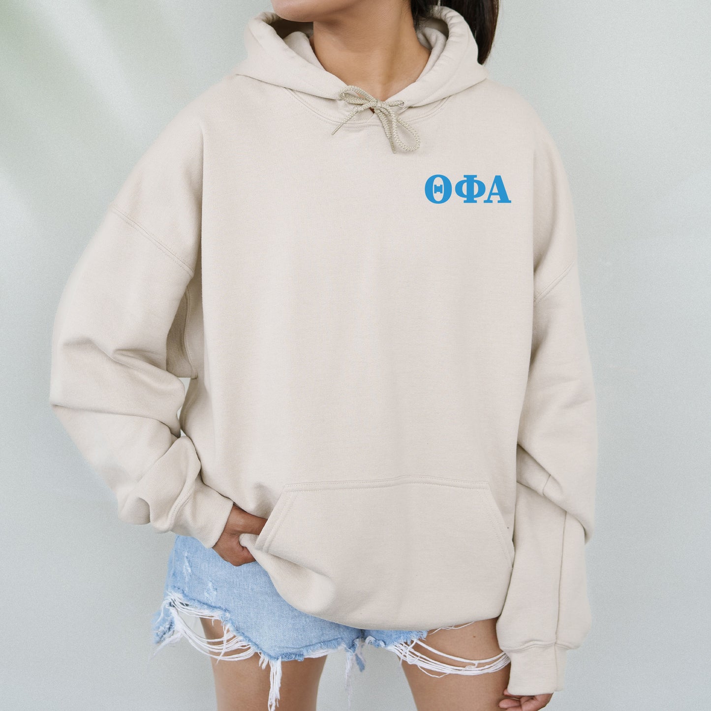 a woman wearing a hoodie with the word aoq on it