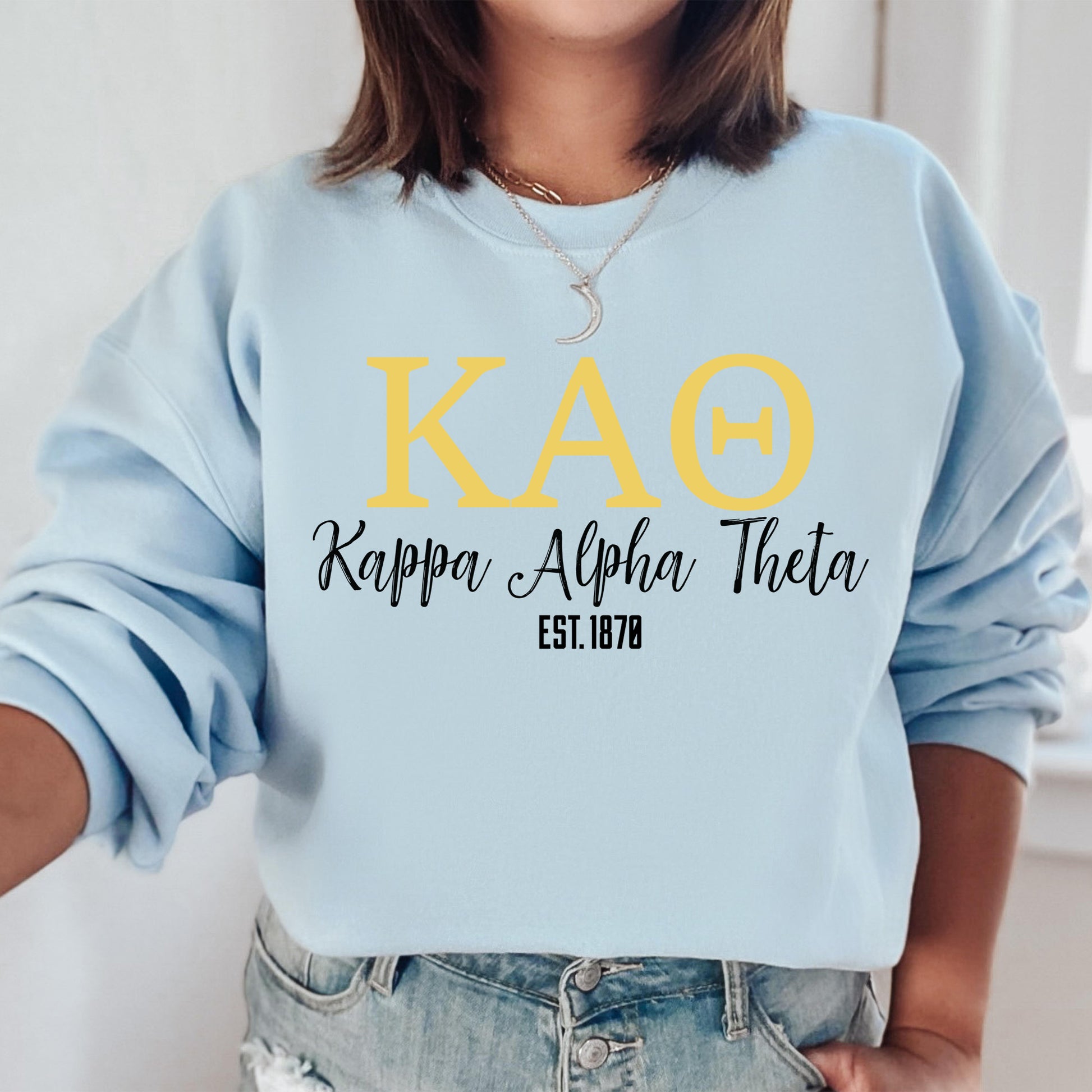 a woman wearing a blue sweatshirt with the words kao on it