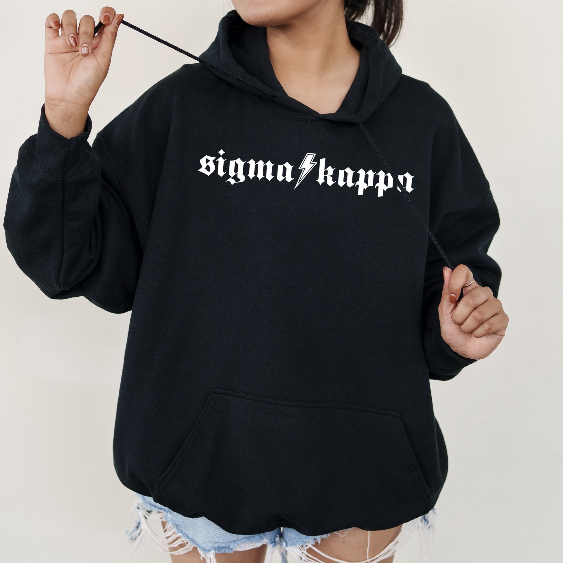 a woman wearing a black hoodie with the word stigmana hippo printed on