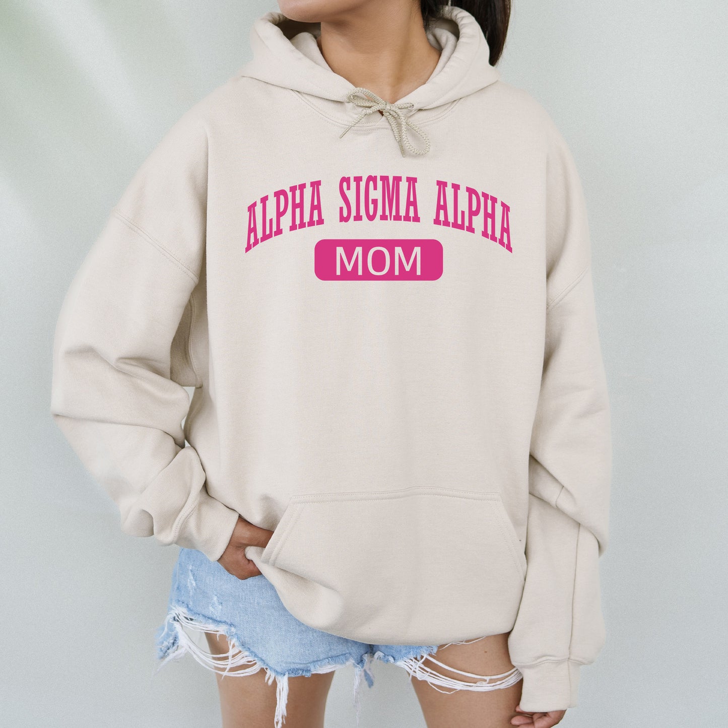 a woman wearing a hoodie with the words, alpaa suma al