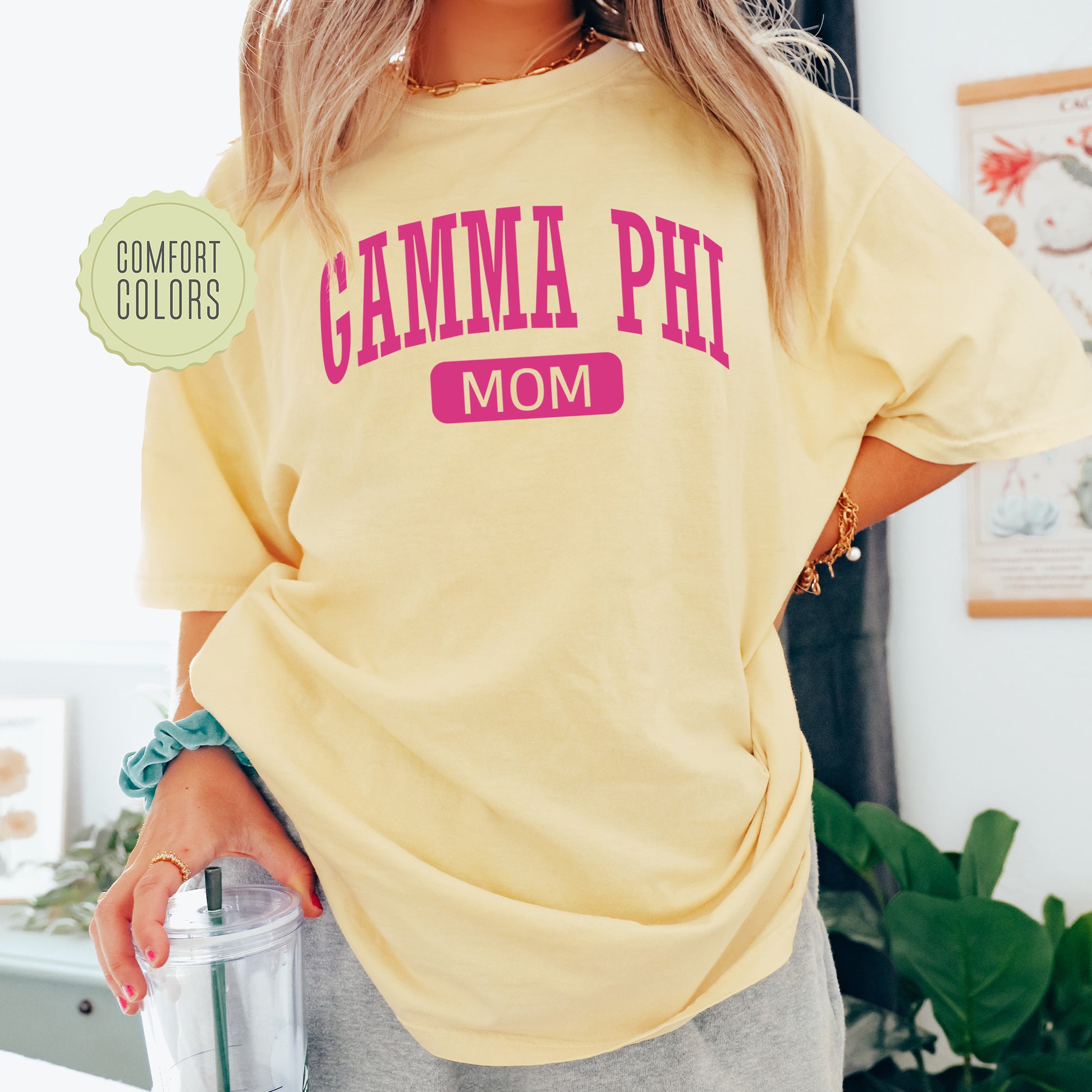 a woman in a yellow shirt is holding a blender