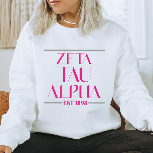 a woman sitting on a chair wearing a white sweatshirt