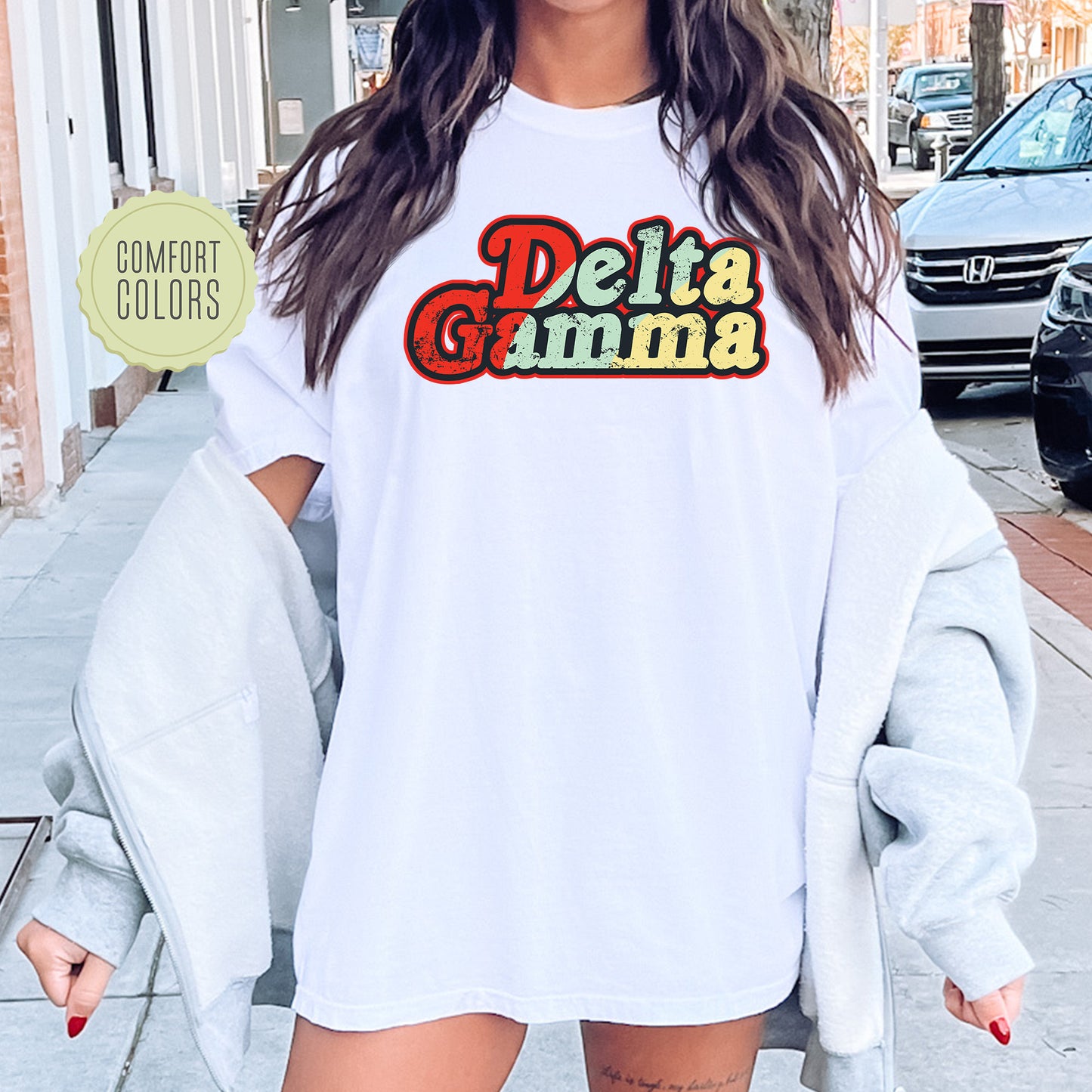 a woman wearing a white shirt with the word delta gama on it