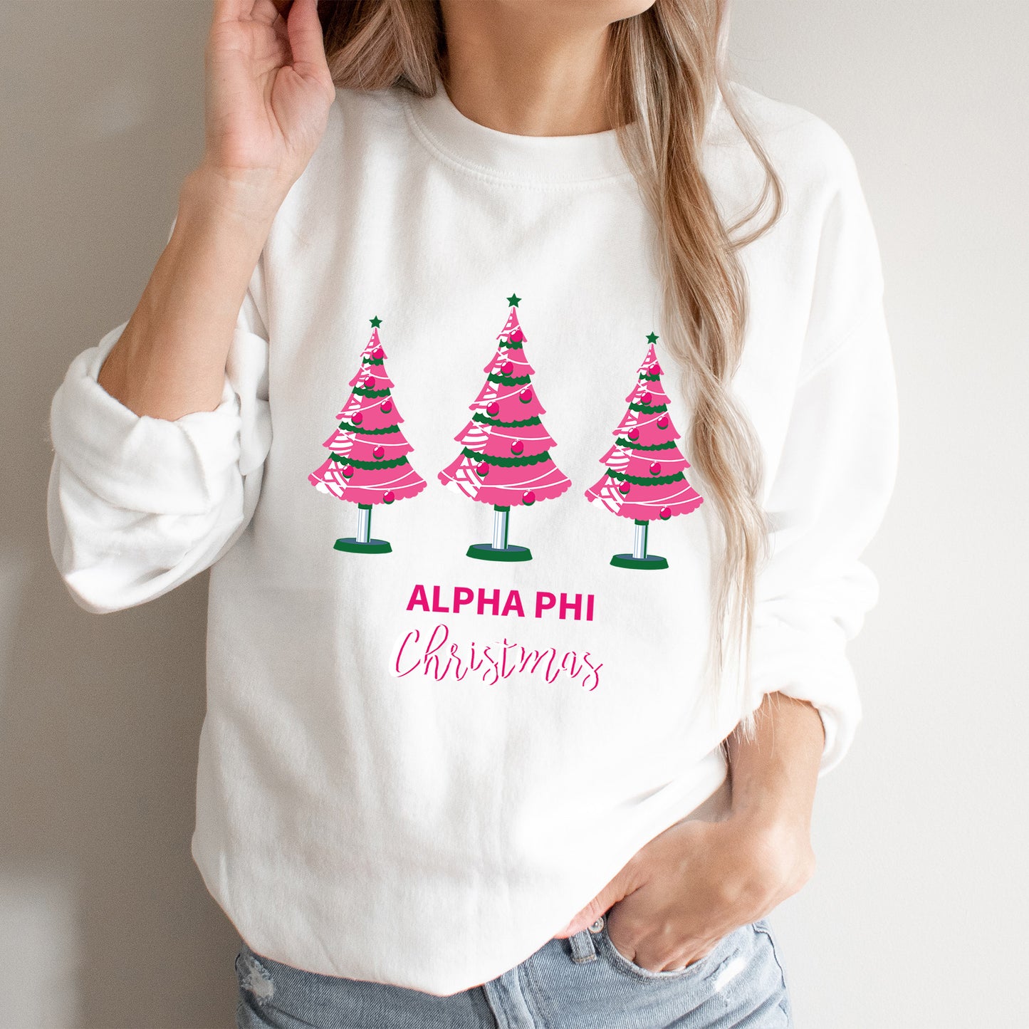 a woman wearing a white shirt with pink trees on it